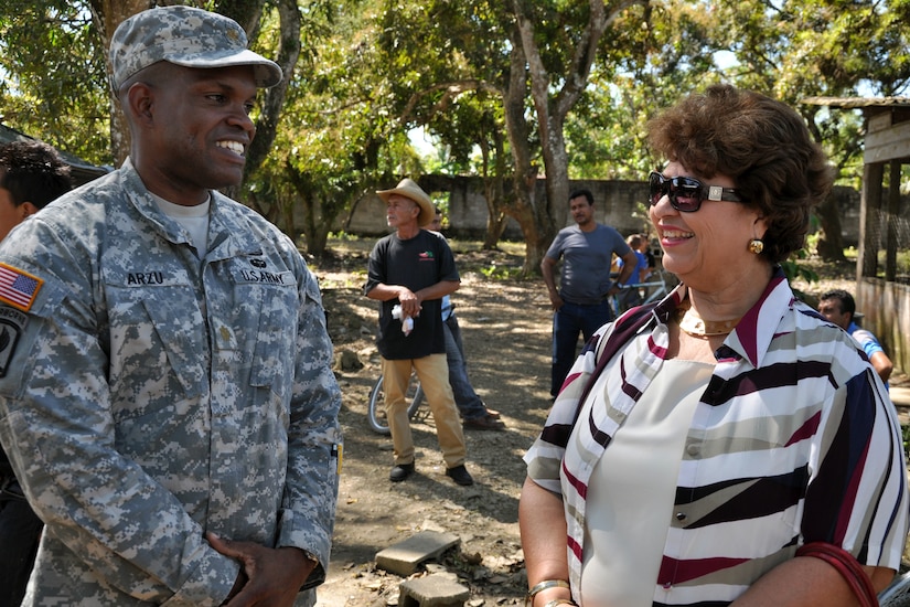 U.S. Army Maj. Juan Arzu visits with Maria Luisa Martell de Matute, Vice-Mayor of Puerto Cortez during a visit to an ongoing Medical Readiness and Training Exercise (MEDRETE) being conducted in the town of Caoba, Department of Cortes, Honduras, Feb. 20, 2014.  Several key leaders from Joint Task Force-Bravo met with Honduran military and civic leaders at the site to observe the medical relief mission and engage in discussion on how to build on the strong relationship between the U.S. and Honduras, and how Joint Task Force-Bravo can continue to partner with Honduras in order to provide assistance to those in need.  (U.S. Air Force photo by Capt. Zach Anderson)