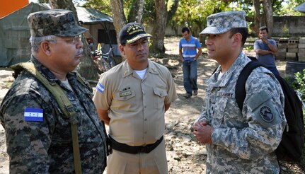 U.S. Army Lt. Col. Frank Melgarejo, Joint Task Force-Bravo Director of Operations, visits with Honduran Army Col. Adolfo Puerto, Chief of Staff of the Honduran 105th Infantry Brigade and Honduran Navy Commander Juan De Jesus during a visit to an ongoing Medical Readiness and Training Exercise (MEDRETE) being conducted in the town of Caoba, Department of Cortes, Honduras, Feb. 20, 2014.  Several key leaders from Joint Task Force-Bravo met with Honduran military and civic leaders at the site to observe the medical relief mission and engage in discussion on how to build on the strong relationship between the U.S. and Honduras, and how Joint Task Force-Bravo can continue to partner with Honduras in order to provide assistance to those in need.  (U.S. Air Force photo by Capt. Zach Anderson)