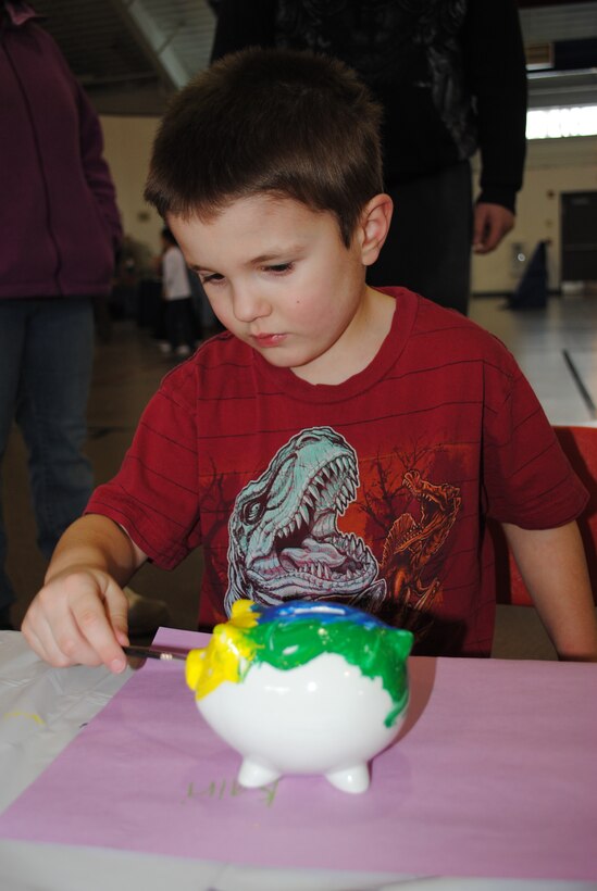 Zach Butters, 5, paints his piggy bank during the 2014 Kids' Financial Day on
Feb. 20, 2014, at Liberty Square on Grand Forks Air Force Base, N.D. The fair was one of two events hosted by the Airman & Family Readiness Center used to kick off this year's Military Saves Week. (U.S. Air Force photo/Staff Sgt. Luis Loza Gutierrez)
