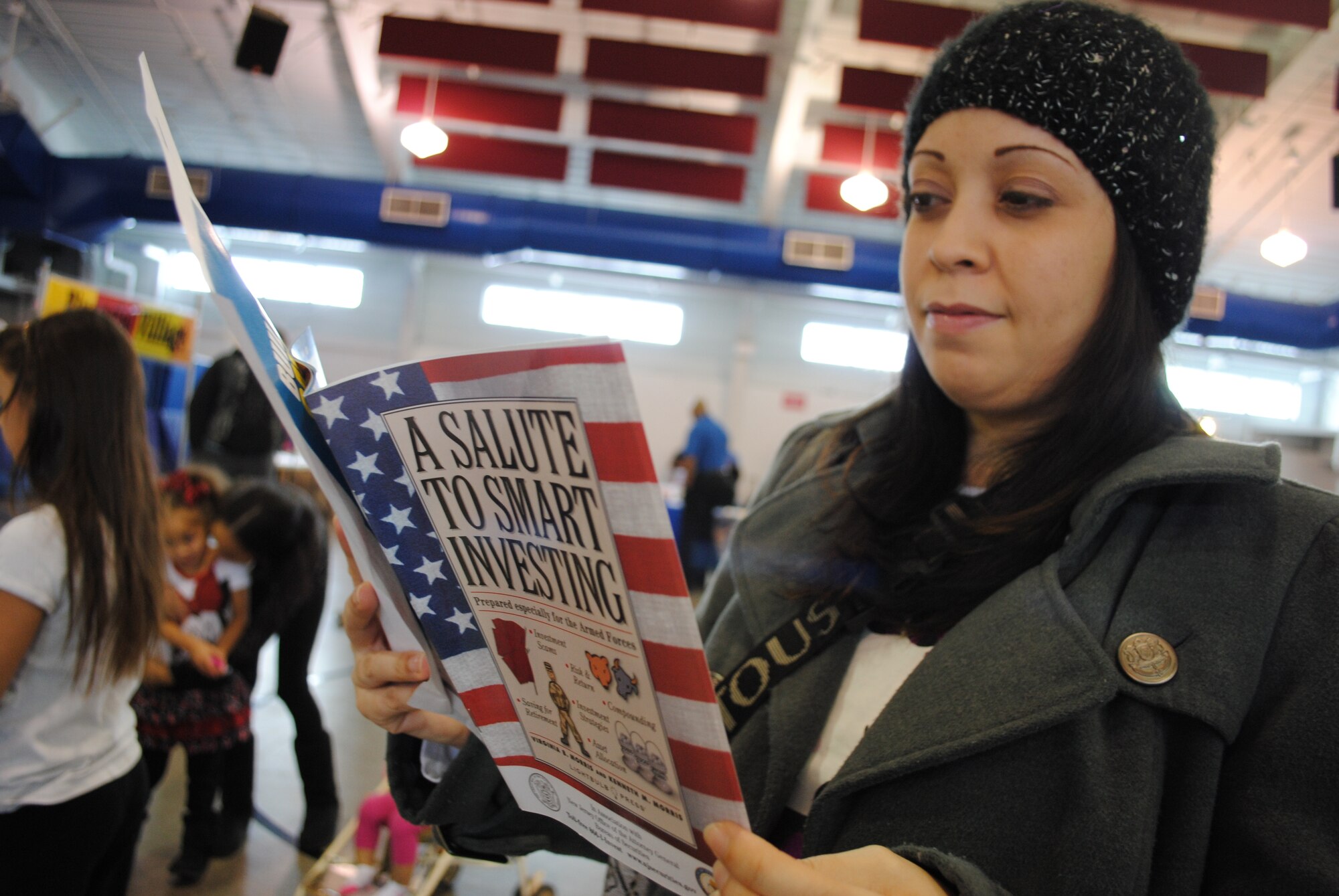 Katherine Diaz Velazquez looks through one of dozens of financial information booklets provided free for guests attending the 2014 Financial Fair on Feb. 20, 2014, at Liberty Square on Grand Forks Air Force Base, N.D. The fair was one of two events hosted by the Airman & Family Readiness Center used to kick off this year's Military Saves Week. (U.S. Air Force photo/Staff Sgt. Luis Loza Gutierrez)
