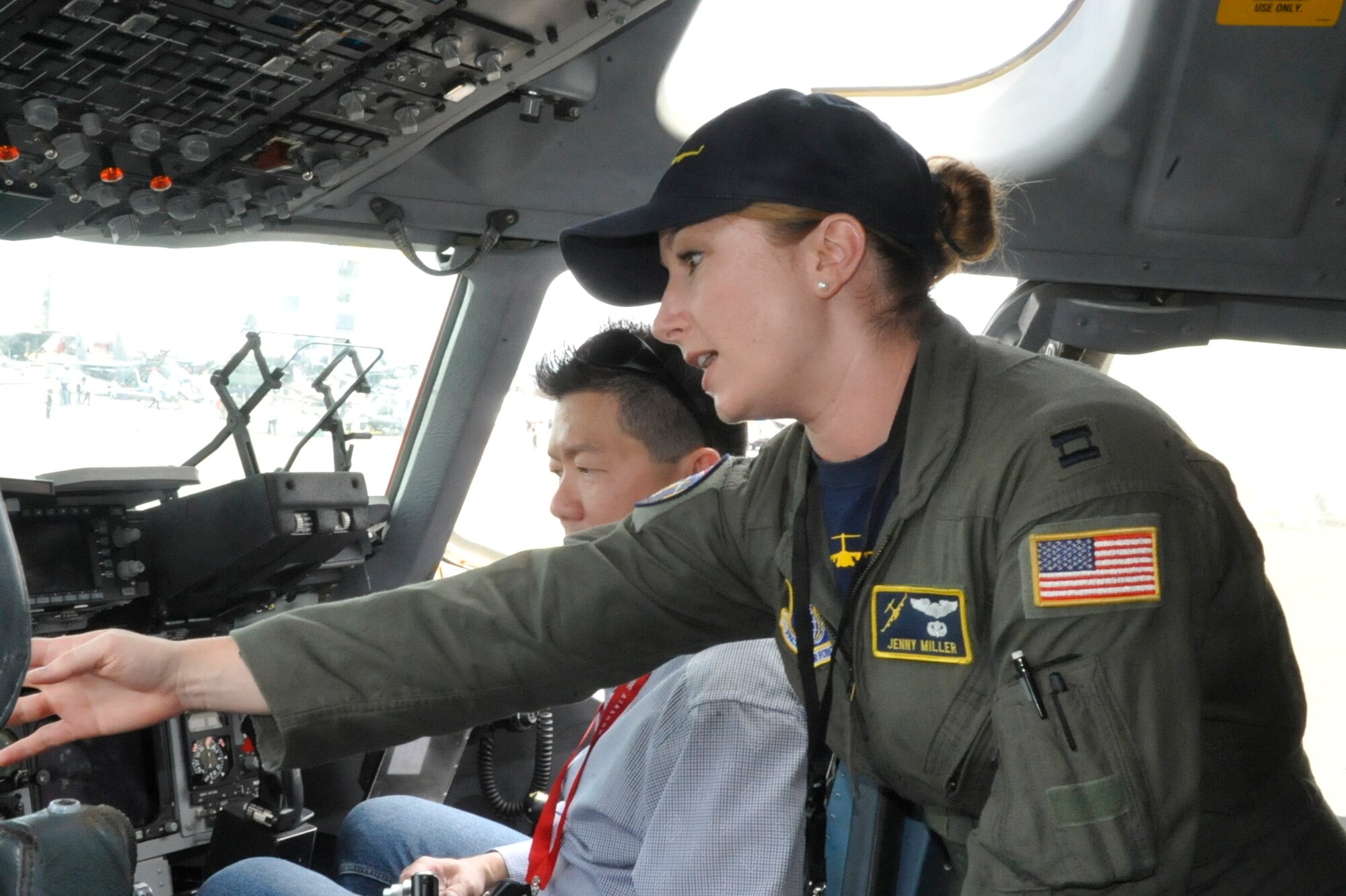 Capt. Jenny Miller, Pacific Air Forces instructor pilot at Joint Base Pearl Harbor-Hickam, Hawaii, explains the abilities of the C-17 Globemaster III to visitors at the 2014 Singapore International Airshow, Feb. 11, 2014. Miller has been flying since 2006 and has over 2,000 flying hours in the C-17, half of which were in a combat zone. (U.S. Air Force photo/Capt. Tamara Fischer-Carter)