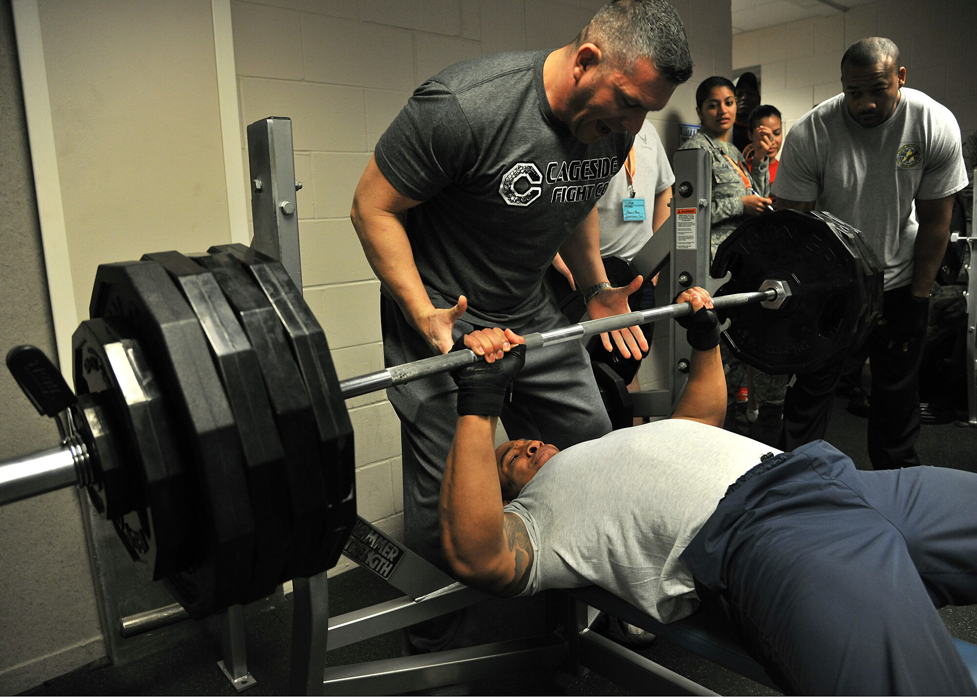 Senior Airman Robin Reese II, 319th Medical Operations Squadron dental technician, benches 460 pounds of weight in the bench press competition during Winter Bash, Feb. 20, 2014, on Grand Forks Air Force Base, N.D. Winter Bash is an annual event designed to boost morale and increase espirt de corps. (U.S. Air Force photo/Senior Airman Xavier Navarro)