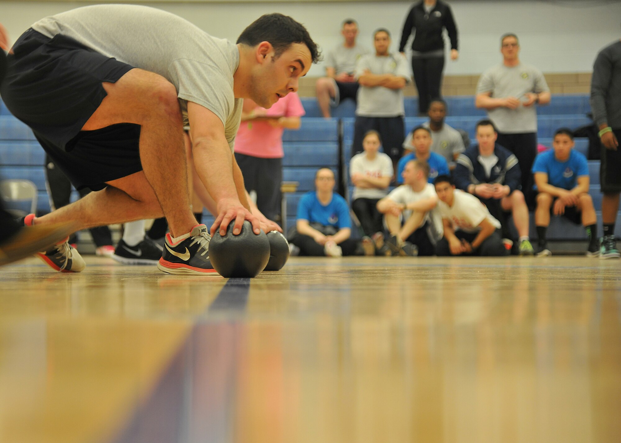 2nd Lt. Nicolas Watson, 319th Logistics Readiness Squadron traffic management function officer in-charge, grabs balls to throw during the dodgeball tournament for Winter Bash, Feb. 20, 2014, on Grand Forks Air Force Base, N.D. Winter Bash is an annual event designed to boost morale and increase espirt de corps. (U.S. Air Force photo/Senior Airman Xavier Navarro)