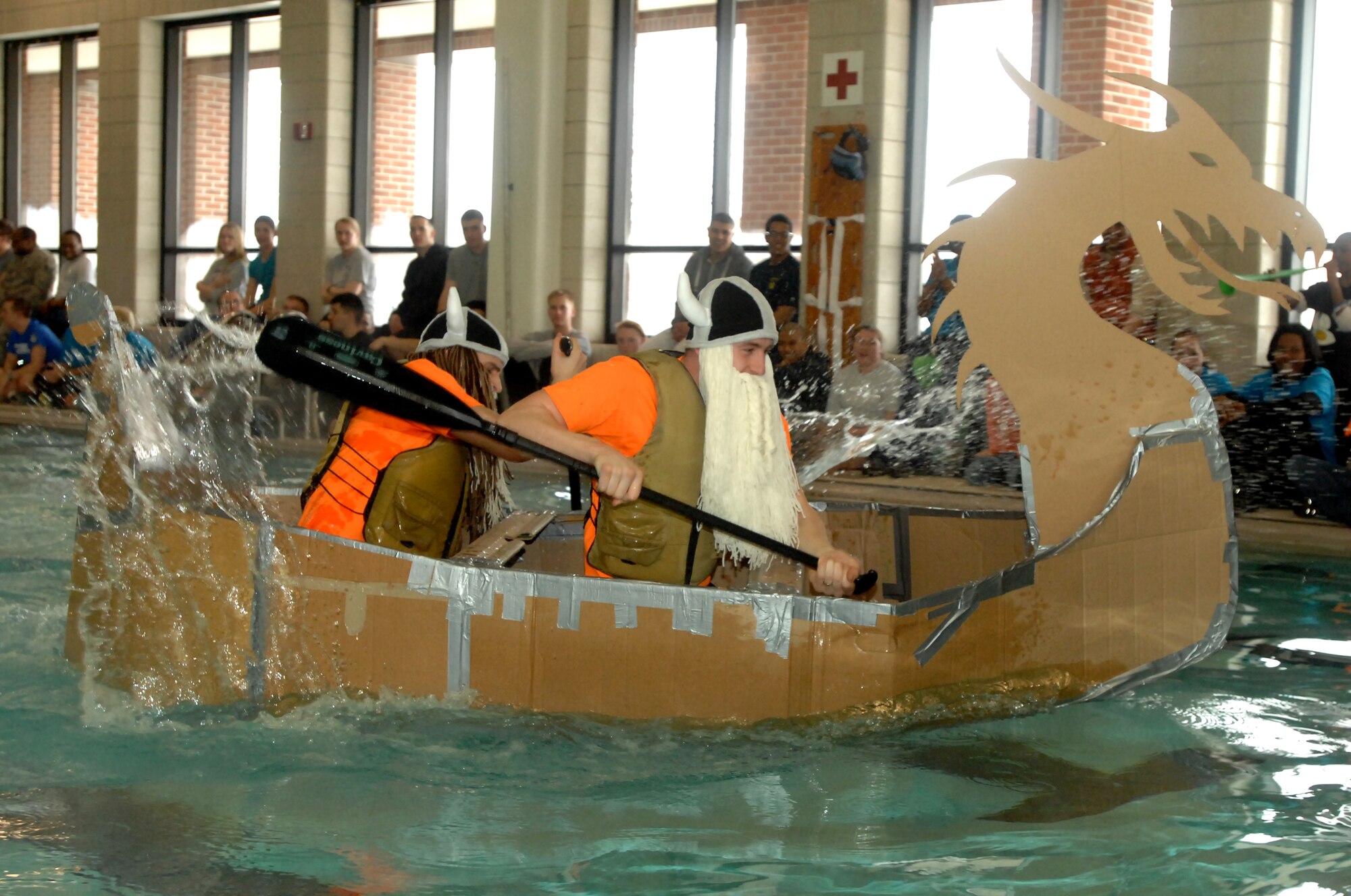 Members of the 319th Contracting Flight near the finish line during the Frosty Sailor Boat Race at the annual Winter Bash celebration held Feb. 20, 2014, on Grand Forks Air Force  Base, N.D. The boat race was one of several events throughout the day that focused on competitive individual and team sports. Winter Bash, like its counterpart, Summer Bash, is an opportunity for Airmen take a break from day-to-day tasks in order to boost morale, unit cohesion and esprit de corps. (U.S. Air Force photo/Staff Sgt. Susan L. Davis)