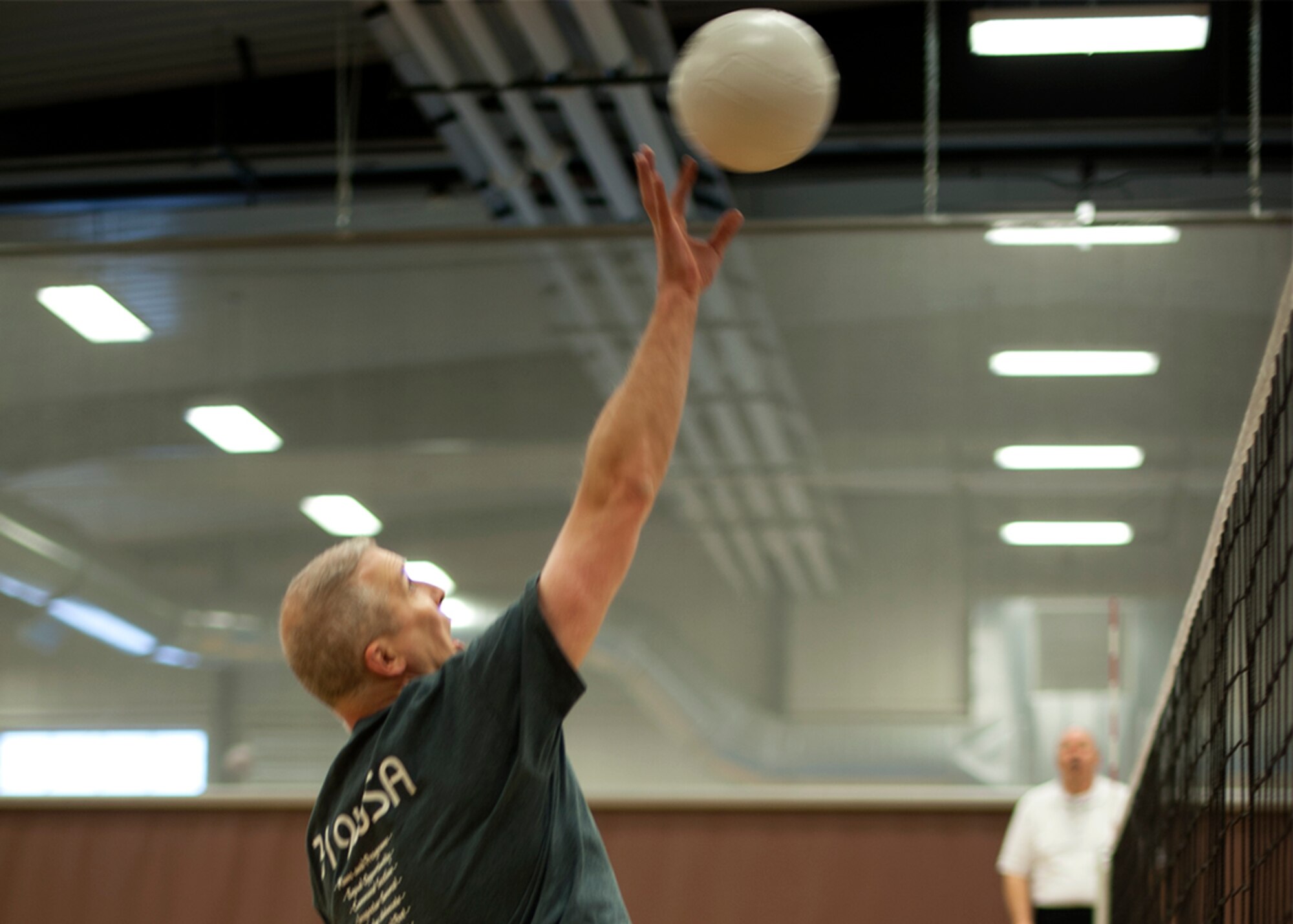 Col. Paul Bauman, 319th Air Base Wing commander, goes up for a spike during a volleyball match at the annual Winter Bash celebration held Feb. 20, 2014, on Grand Forks Air Force Base, N.D. Winter Bash, like its counterpart, Summer Bash, is an opportunity for Airmen to take a break from day-to-day tasks in order to boost morale, unit cohesion and esprit de corps. (U.S. Air Force photo/Staff Sgt. Andrew J. Helmkamp)
