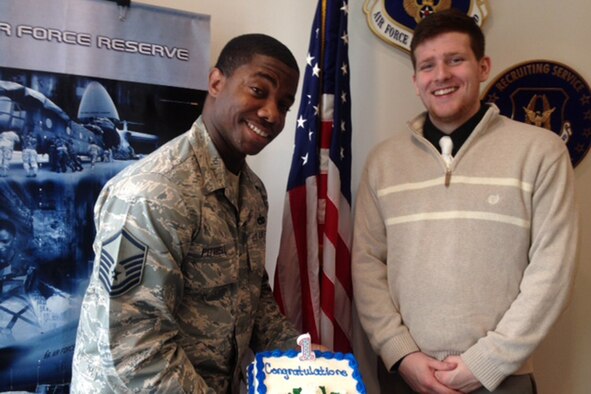 YOUNGSTOWN AIR RESERVE STATION, Ohio – Air Force Reserve Master Sgt. Dartanion Pittrell, Youngstown-area Air Force Reserve line recruiter, holds a cake celebrating the first recruitment he has completed during his new assignment here, Feb. 21, 2014. Standing to Pittrell’s right is his first enlistee, Mr. Jacob Searle, a student at nearby Kent State University and a native of Medina, Ohio. Pittrell recently joined the YARS recruiting team and was instrumental in bringing Searle on as the newest Citizen Airman assigned to the YARS-based 910th Airlift Wing’s 910th Security Forces Squadron. U.S. Air Force photo by Senior Master Sgt. Jo Ann Shaw. 