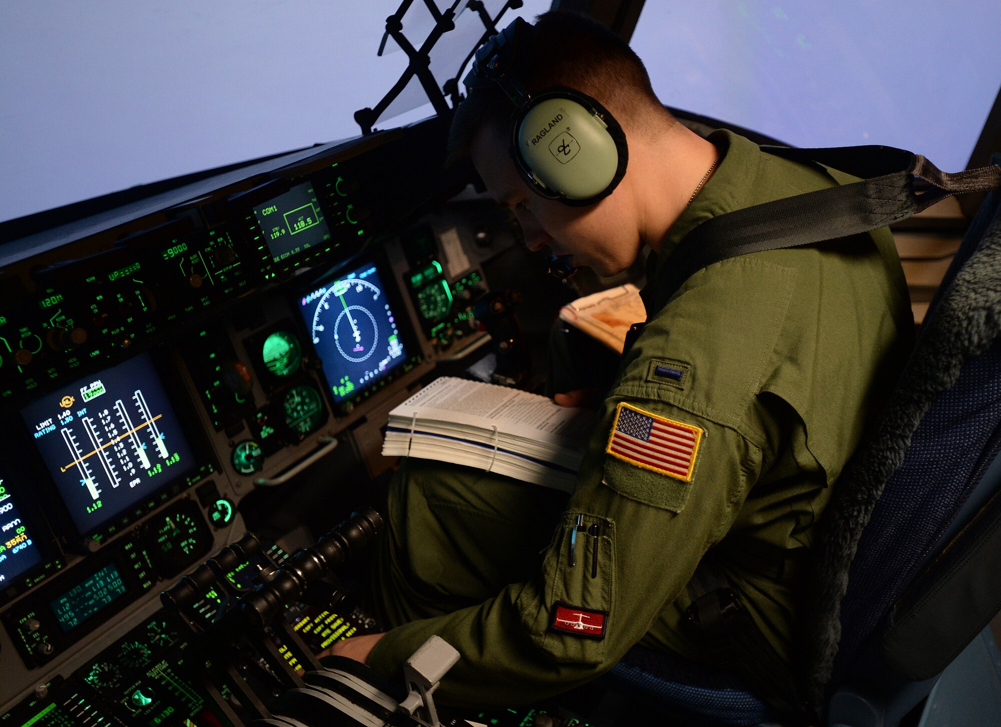 1st Lt. Taylor Ragland, 535th Airlift Squadron pilot, runs through a checklist during a simulated in-air emergency in a C-17 Globemaster III simulator during a quarterly training session at Joint Base Pearl Harbor-Hickam, Hawaii, Feb. 18, 2014. Ragland is a C-17 pilot, and trains extensively using the simulator, designed to give pilots a realistic feel for in-air tactical and emergency operations. (U.S. Air Force photo/Staff Sgt. Alexander Martinez)