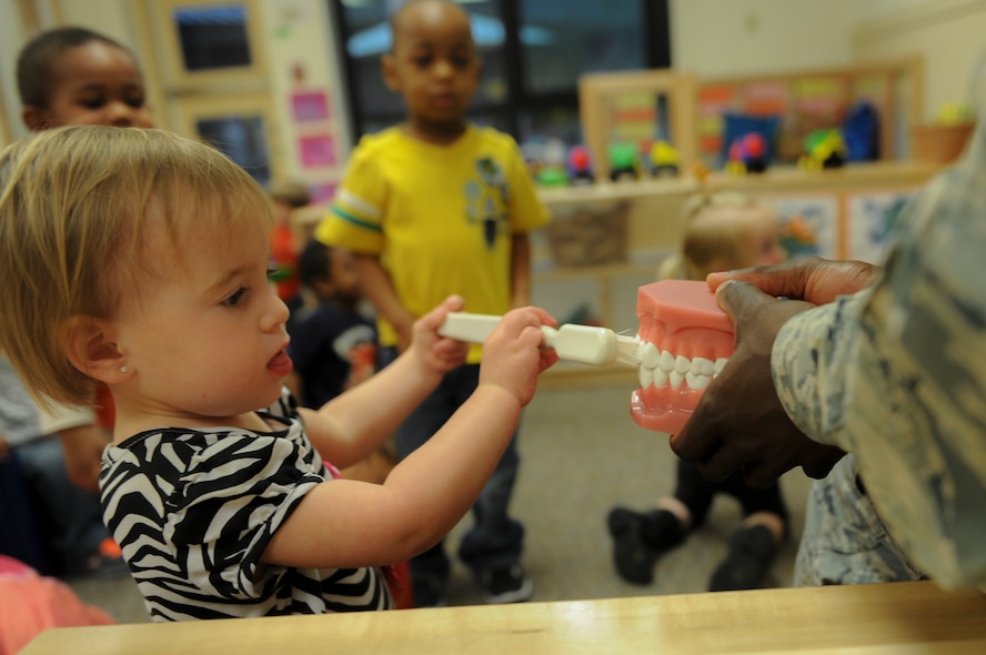 Isabella Bacha, daughter of U.S. Air Force Senior Airmen Donald Bacha, 23d Security Forces Squadron combat arms training and maintenance instructor, practices brushing teeth at Moody Air Force Base, Ga., Feb. 21, 2014. The Moody dental clinic educated children throughout the month of February on proper dental hygiene for Children’s Dental Health Month. (U.S. Air Force photo by Airman 1st Class Alexis Millican/Released)