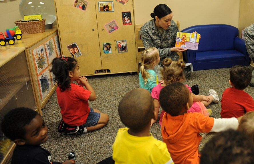 U.S. Air Force Capt. Jamie Smith, 23d Aerospace Medicine Squadron dentist, reads a story about brushing teeth at Moody Air Force Base, Ga., Feb. 21, 2014. Smith also taught the children a new song to sing when they brush their teeth. (U.S. Air Force photo by Airman 1st Class Alexis Millican/Released)
