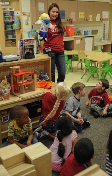 Elizabeth Halloway uses a hand puppet, Dolly the Dentist, to speak to children from the Child Development Center on the importance of dental care at Moody Air Force Base, Ga., Feb. 21, 2014. Children should brush their teeth for a minimum of two minutes at least twice a day. (U.S. Air Force photo by Airman 1st Class Alexis Millican/Released)