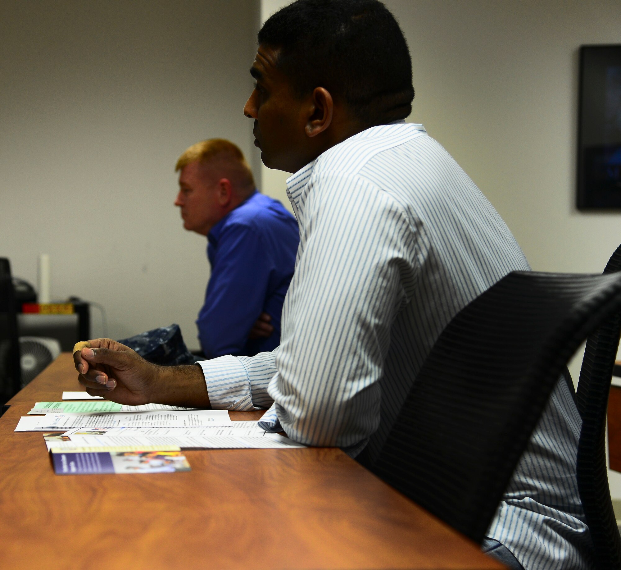 U.S. Navy Chief James Thorpe, C5F MOC leading chief petty officer, listens during a Troops to Teachers seminar Feb. 20, 2014 at MacDill Air Force Base, Fla. During the seminar, representatives from Hillsborough and Polk County school districts, along with Hillsborough Community College explained different options for teaching and obtaining certification. (U.S. Air Force photo by Senior Airman Jenay Randolph/Released)