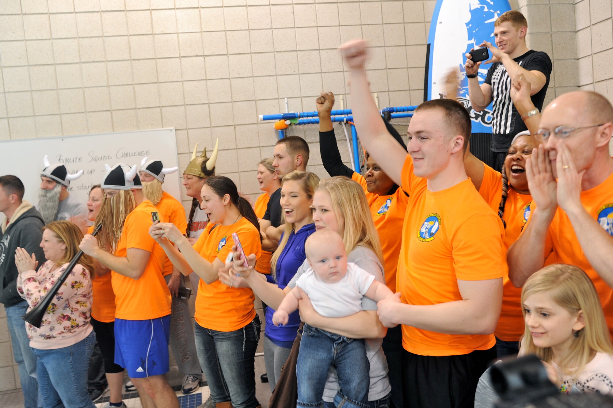 Fans from the 319th Contracting Flight cheer for their boat during the "Frosty Sailor Boat Race" in the aquatic center at the annual Winter Bash celebration on Grand Forks Air Force Base, N.D., Feb. 20, 2014. Winter Bash, like its counterpart, Summer Bash, is an opportunity for Airmen take a break from day-to-day tasks in order to boost morale, unit cohesion and esprit de corps. (U.S. Air Force photo/Tim Flack)