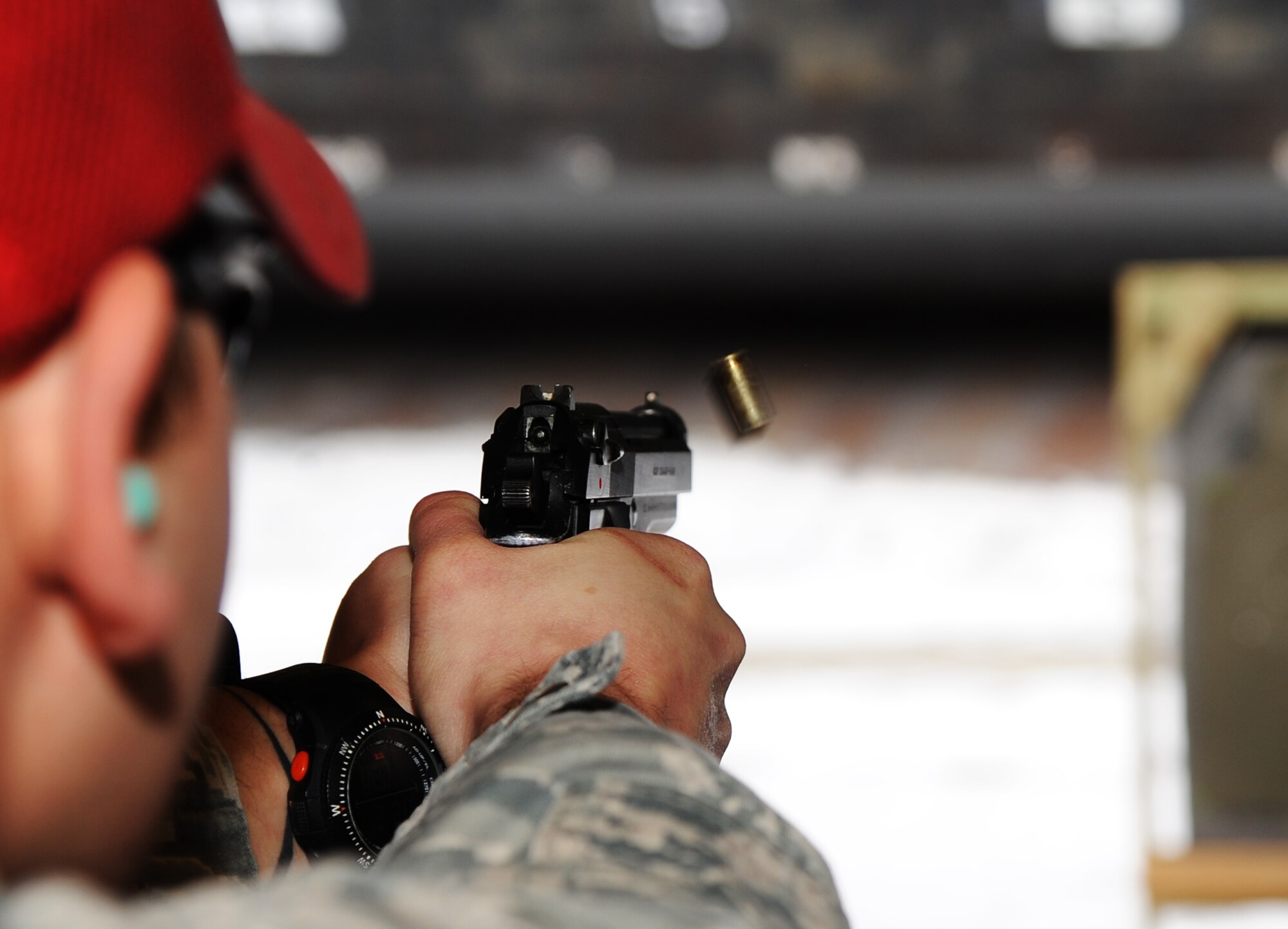Staff Sgt. Jeremy Smith, 5th Security Forces Combat Arms Training instructor, fires an M-9 pistol round at a target at Minot Air Force Base N.D., Feb. 19, 2014. CATM instructors are often excellent marksmen in addition to being technical experts on the weapons they teach. (U.S. Air Force photo/Senior Airman Andrew Crawford)