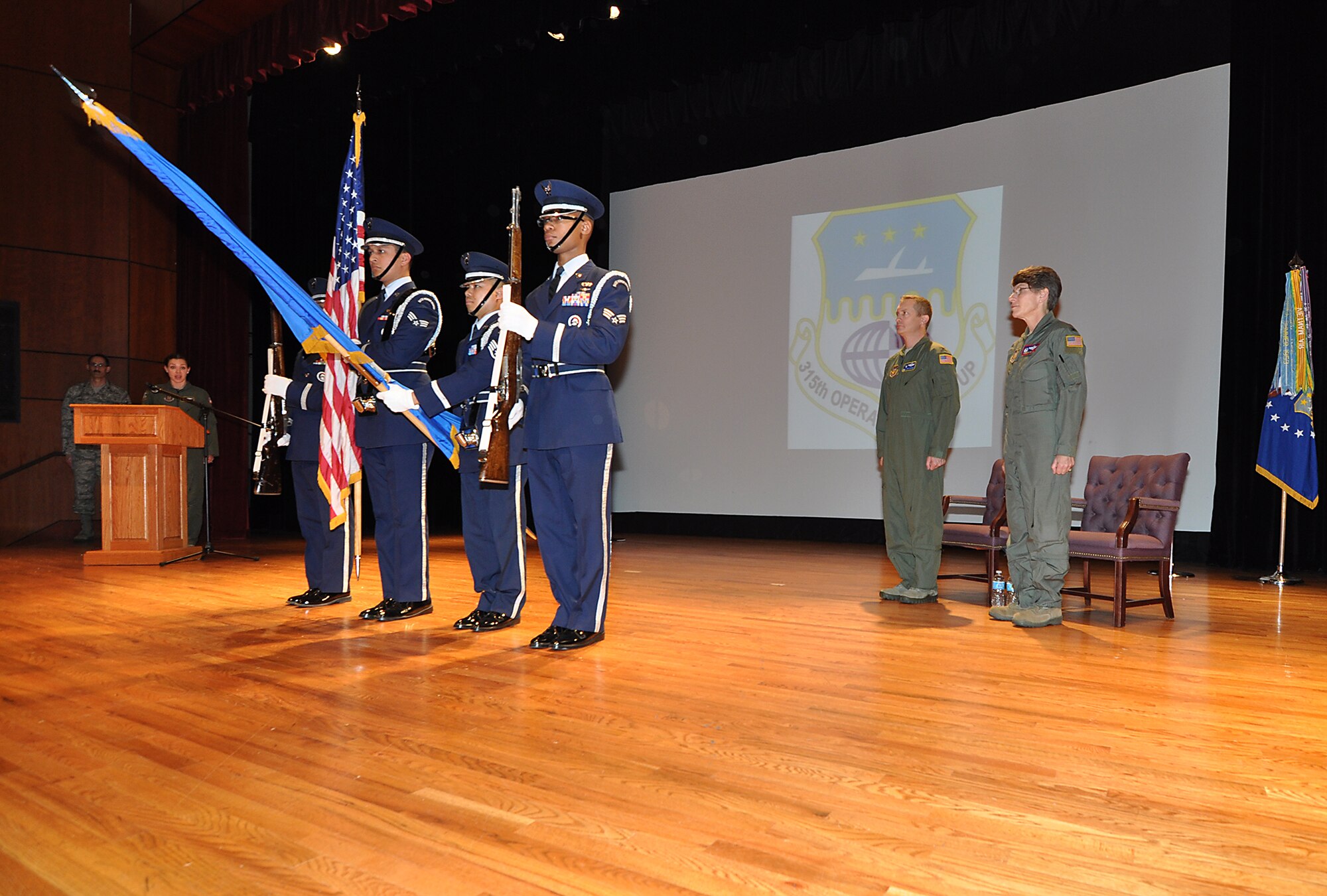 (Far left) Capt. Lyndsey Moynihan, 317th Airlift Squadron, sings the National Anthem during Col. Caroline Evernham's assumption of command ceremony at Joint Base Charleston Feb. 21. Evernham (far right) is the new 315th Operations Group commander, and the first female Airman to command the group. (U.S. Air Force Reserve photo by Michael Dukes)