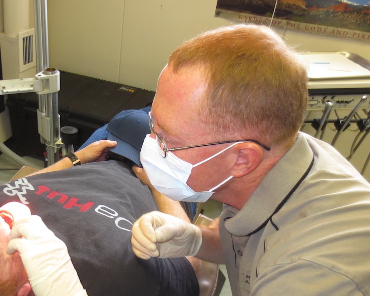 U.S. Air Force Maj. Andrew Allen, 7th Aerospace Medicine Squadron, evaluates a patient with an urgent dental issue Jan. 17, 2014, at McMurdo Station, Ross Island, Antarctica. During his deployment, Allen was able to use knowledge and experience he gained at Dyess Air Force Base to ensure the highest level of care for his patients in Antarctica. (Courtesy photo)