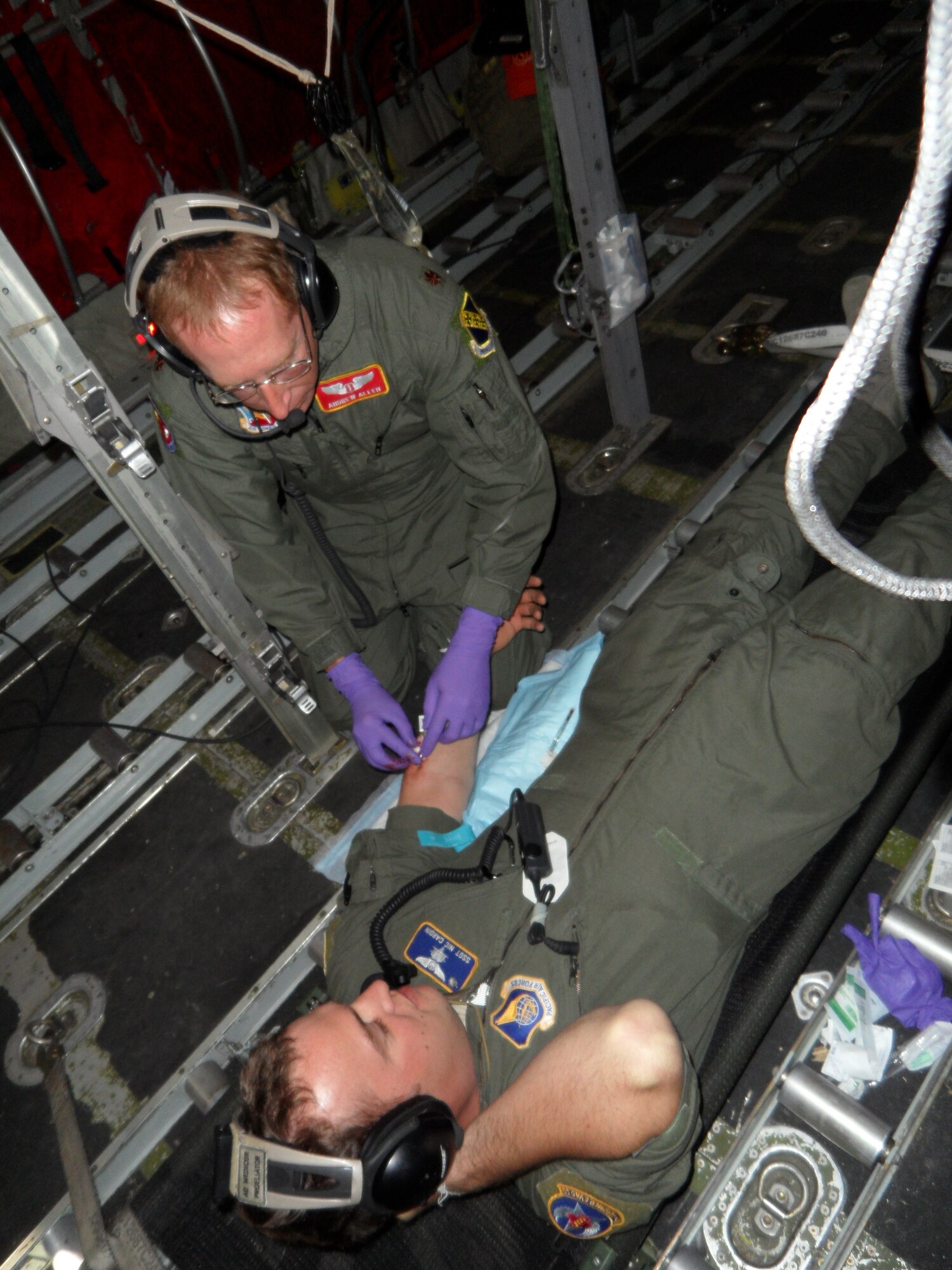 U.S. Air Force Maj. Andrew Allen, 7th Aerospace Medicine Squadron, inserts an intravenous line into Staff Sgt. Nicholas Cardin, 18th Air Evacuation Squadron, during an during in-flight resuscitation training Jan. 10, 2014, at Ross Island, Antarctica. Allen not only provided medical care for aviators, but had primary medical responsibility for all military personnel on station, which includes members of the U.S. Air Force, U.S. Army, U.S. Navy and U.S. Coast Guard. Additionally, he supported casualty evacuation missions and patient movement across the continent. (Courtesy photo)  