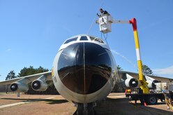 Workers from Louis Berger Services take advantage of warm, spring-like weather to pressure wash the C-141 static display at the Air Park, Feb. 21, 2014, on Joint Base Charleston – Air Base, S.C.  (U.S. Air Force photo/Eric Sesit)
