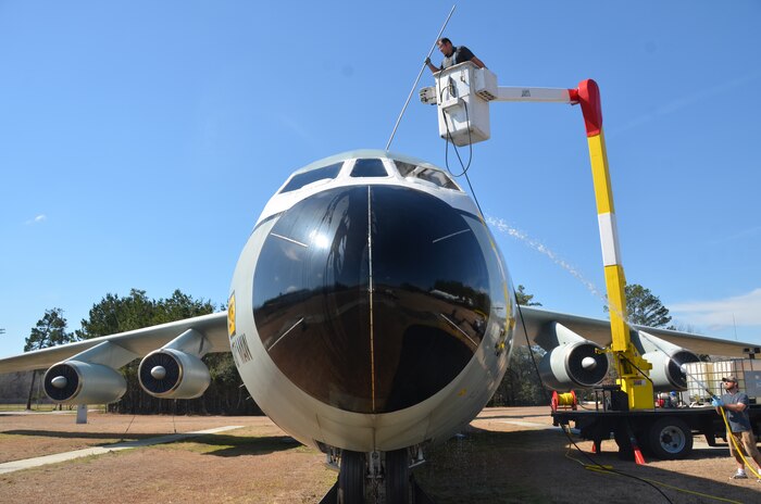 Workers from Louis Berger Services take advantage of warm, spring-like weather to pressure wash the C-141 static display at the Air Park, Feb. 21, 2014, on Joint Base Charleston – Air Base, S.C.  (U.S. Air Force photo/Eric Sesit)