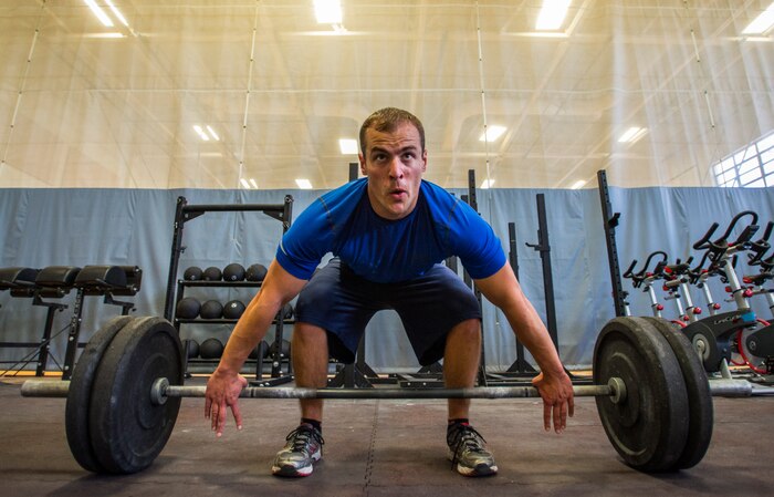 1st Lt. Tyler Benjamin, 17th Airlift Squadron officer  , prepares to perform a deadlift Feb. 20, 2014, at the Fitness Center on Joint Base Charleston – Air Base, S.C. The CrossFit program is designed to be scalable, where every exercise is modified to each individual’s capabilities, making it a great workout regardless of fitness level. (U.S. Air Force photo/ Airman 1st Class Clayton Cupit)