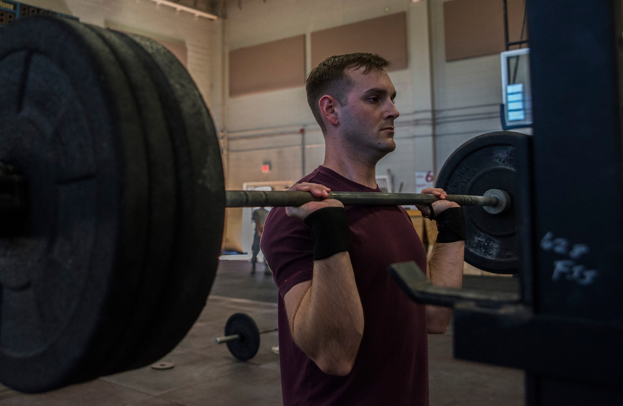 Airman 1st Class Jake Palmer, 628th Medical Group public health technician, concentrates on his weight lifting form   Feb. 19, 2014, at the Fitness Center on Joint Base Charleston – Air Base, S.C. The CrossFit program is designed to be scalable, where every exercise is modified to each individual’s capabilities, making it a great workout regardless of fitness level. (U.S. Air Force photo/ Airman 1st Class Clayton Cupit)