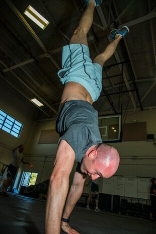 Matt Reid , CrossFit enthusiast, performs a handstand walk workout Feb. 19, 2014, at the Fitness Center on Joint Base Charlestson – Air Base, S.C. The handstand walk is one of many exercises the CrossFit program utilizes to build strength and endurance. (U.S. Air Force photo/ Airman 1st Class Clayton Cupit)