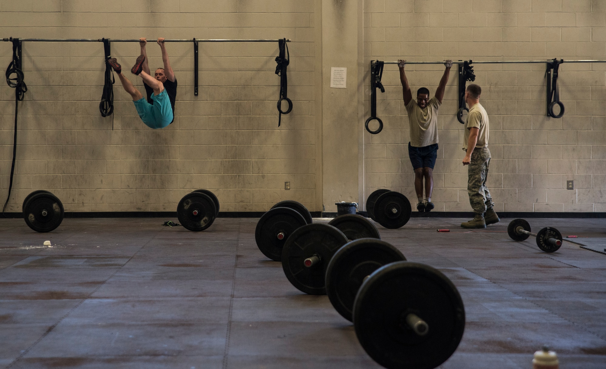 Joint Base Charleston CrossFit members perform single sides Feb. 19, 2014, at the Fitness Center on Joint Base Charleston – Air Base, S.C. The CrossFit program is designed to be scalable, where every exercise is modified to each individual’s capabilities, making it a great workout regardless of fitness level. (U.S. Air Force photo/ Airman 1st Class Clayton Cupit)