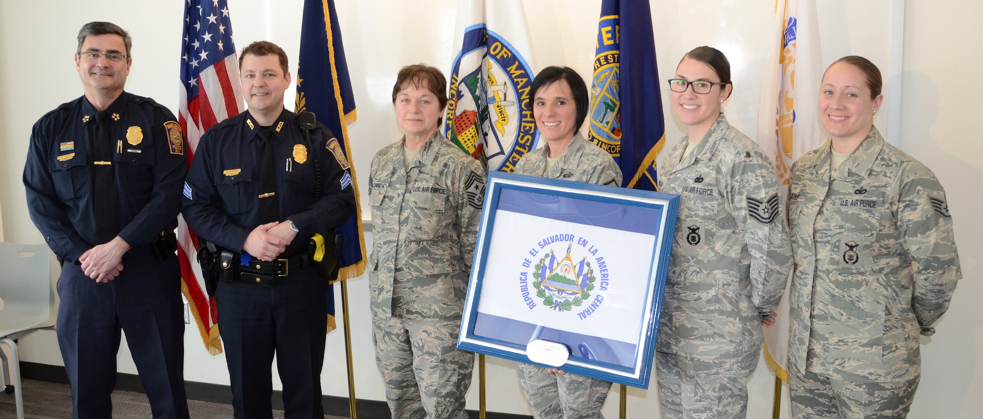 U.S. Airmen with the 157th Air Refueling Wing, New Hampshire Air National Guard present the El Salvador Flag to the Manchester Police Department as a tolken of appreciation, February 20, 2014, Manchester, N.H.  The police department donated equipment used in El Salvador in 2013 as part of the N.H. National Guard State Partnership Program. (Air National Guard photo by 1st Lt. Alec Vargus/Released) 