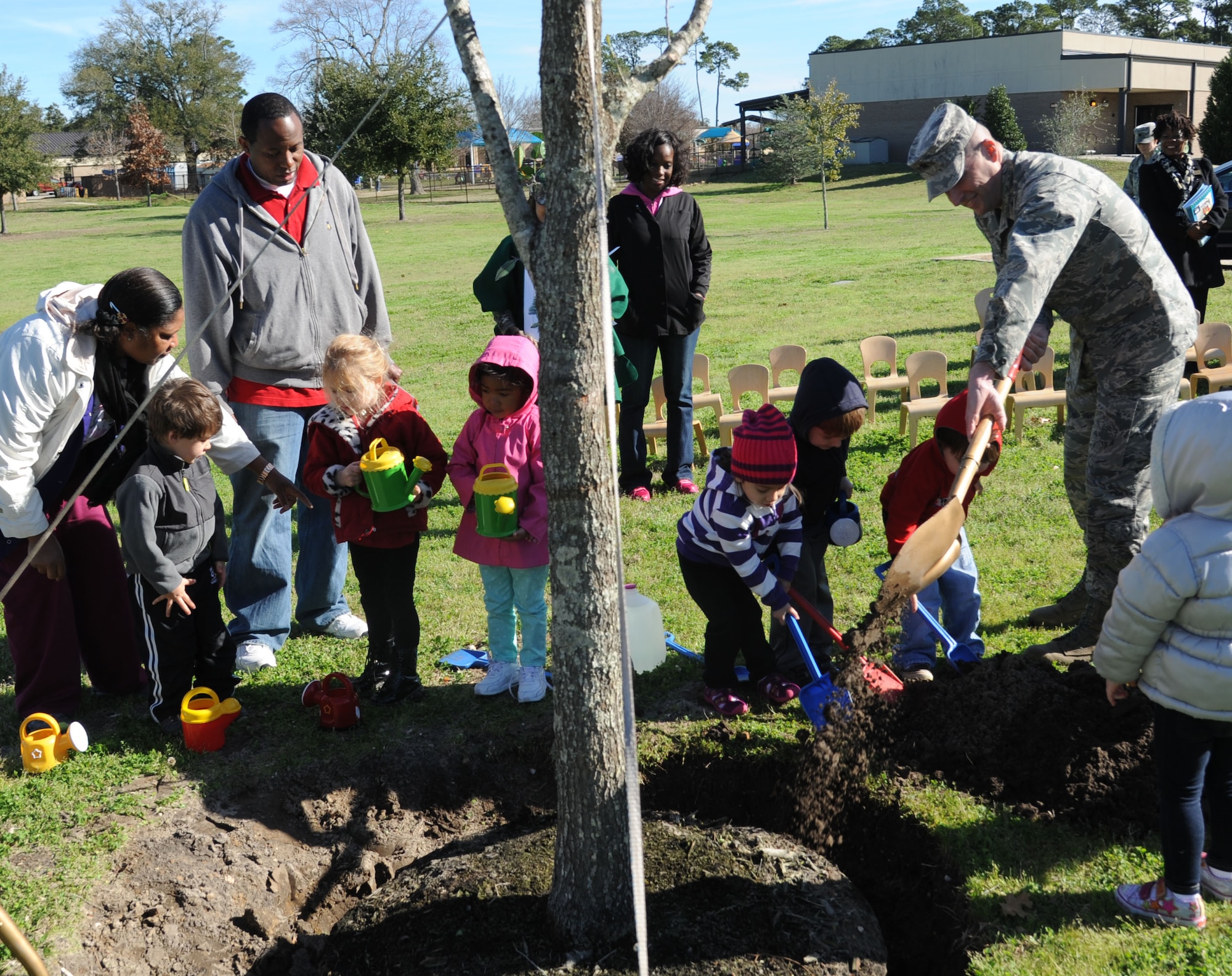 Brig. Gen. Patrick Higby, 81st Training Wing commander, plants a tree in honor of Arbor Day along with a preschool class at the child development center Feb. 21, 2014, at Keesler Air Force Base, Miss.  The Tree City USA award was presented to Keesler for the 21st consecutive year for its tree management program.  (U.S. Air Force photo by Kemberly Groue)