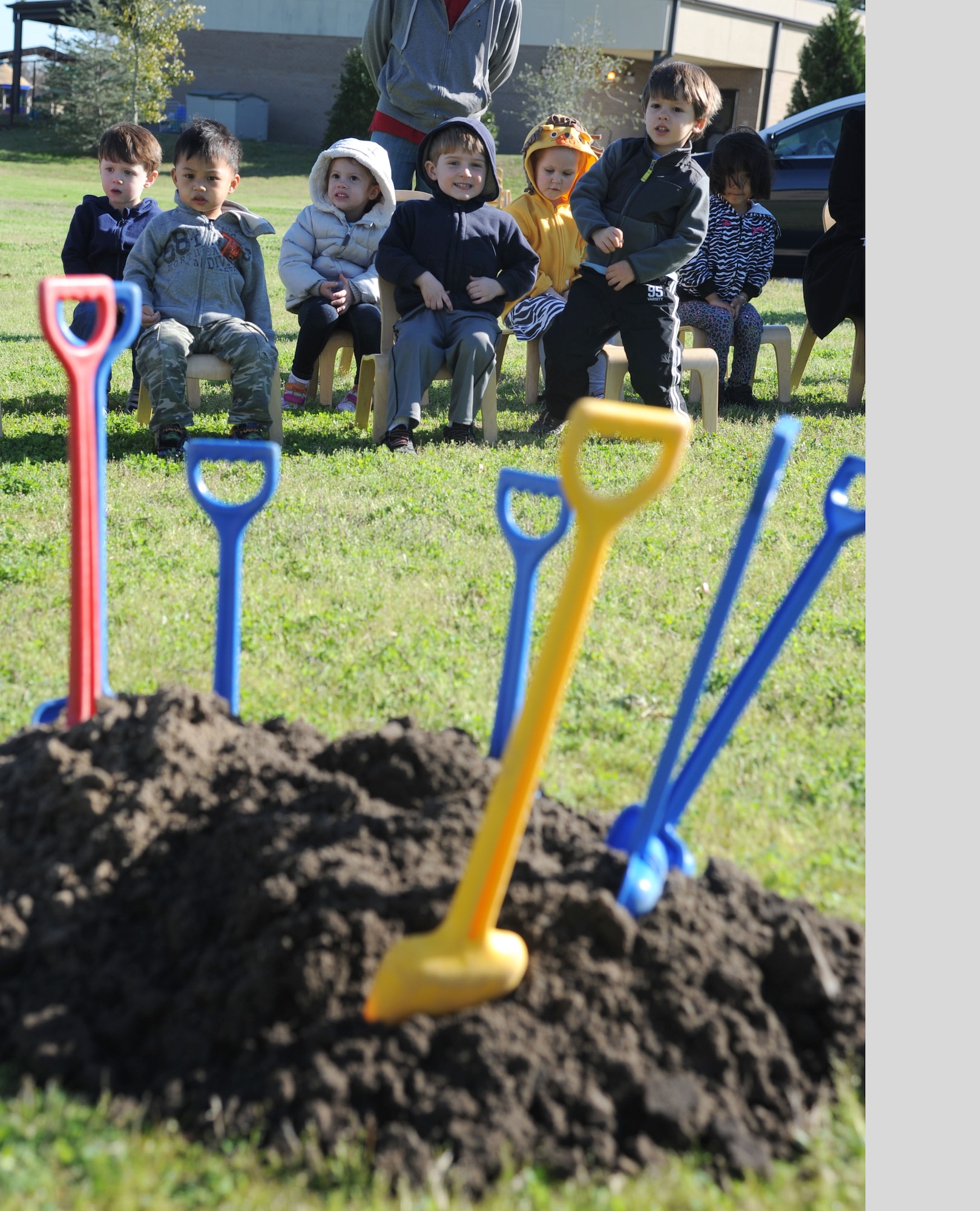 A preschool class at the child development center sits behind a mound of dirt and shovels that will be used during a tree-planting ceremony in honor of Arbor Day Feb. 21, 2014, at Keesler Air Force Base, Miss. The Tree City USA award was presented to Keesler for the 21st consecutive year for its tree management program.  (U.S. Air Force photo by Kemberly Groue)