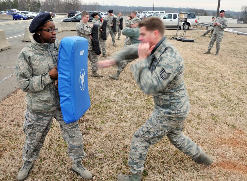 U.S. Air Force Technical Sgt. James Newman, Senior Airman Marissa Miller and other members of the 145th SFS emulate closed ASP baton strikes.  Airmen assigned to the 145th SFS must train as part of a yearly requirement to keep their certification in non-lethal ASP current. The training was conducted at the North Carolina Air National Guard base, Charlotte Douglas Intl. airport, February 9, 2014. (U.S. Air National Guard photo by Senior Airman Laura Montgomery, 145th Public Affairs/Released)