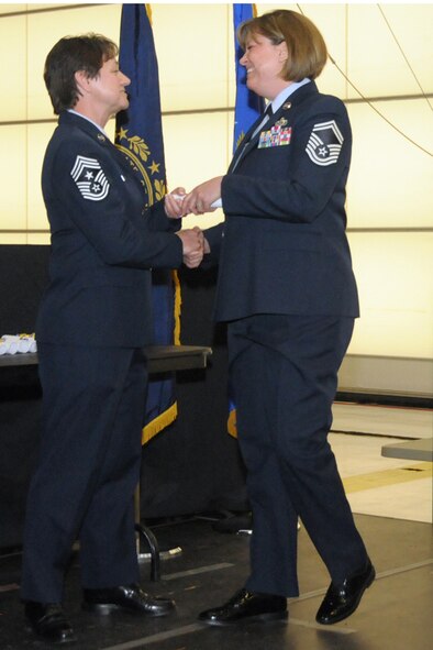 Senior Master Sgt. Tammy L. LaKemper receives her Community College of the Air Force degree from Chief Master Sgt. Brenda Blonigen during the 2014 CCAF commencement ceremony, Pease Air National Guard Base, N.H. February 8, 2014. Thirty-three members of the wing graduated with CCAF associate degrees at the ceremony. (N.H. Air National Guard photo by Staff Sgt. Curtis J. Lenz)
