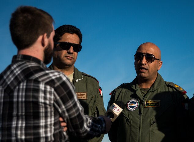 Lt. Col. Abdulaziz Al-Loghani (center), and Lt. Col. Khaled Al-Shami (right), both pilots from the Kuwait Air Force’s 41st Transport Squadron, are interviewed by a local Charleston, S.C., news station after exiting a C-17 Globemaster III at Joint Base Charleston – Air Base, Feb. 14, 2014.The Kuwait Air Force members were embedded with 17th Airlift Squadron for the last month, receiving “seasoning” training on the C-17. (U.S. Air Force photo/ Senior Airman Dennis Sloan)