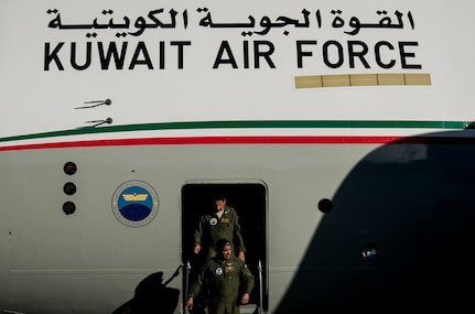 Members of the Kuwait Air Force exit a C-17 Globemaster III at Joint Base Charleston – Air Base, Feb. 14, 2014, en route to Kuwait, where they delivered their nation’s first C-17. The Kuwait Air Force airmen were embedded with 17th Airlift Squadron for the last month, receiving “seasoning” training on the C-17. (U.S. Air Force photo/ Senior Airman Dennis Sloan)