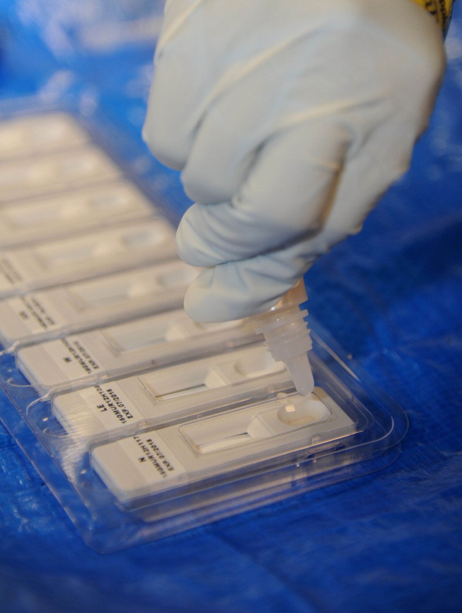 A biological agent identification kit, which helps to identify hazardous solids, is being used by members of the 81st Aerospace Medicine Squadron bioenvironmental team during a Chemical, Biological, Radiological, Nuclear, and high-yield Explosive exercise scenario Feb. 20, 2014, at Wolfe Hall, Keesler Air Force Base, Miss.  The exercise scenario began with a group of Airmen moving old boxes from a storage room where a box containing a bag of powder dropped, causing it to get onto several of the Airmen.  Immediately, the Airmen simulated eye irritations, runny noses, difficulty breathing and burning sensations on their hands and faces from exposure to the agent.  (U.S. Air Force photo by Kemberly Groue)