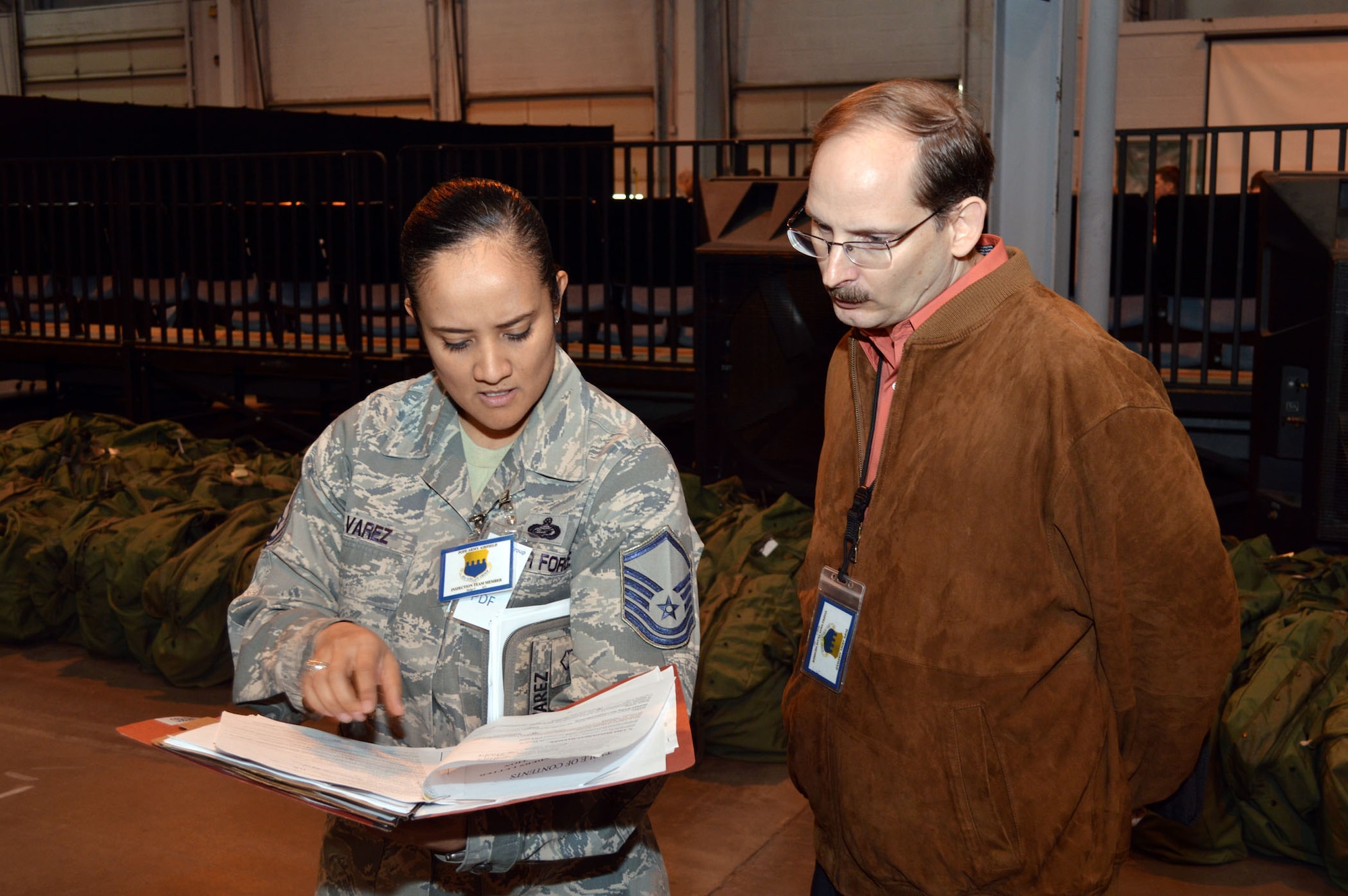 Master Sgt. Claudia Alvarez, 43d Force Support Squadron, and James McVay, 43d Airlift Group, review a mobility folder as members of the Group’s exercise evaluation team during a 43d Airlift Group mobility exercise here Feb. 20. The four-day exercise prepared 153 personnel and 200 short tons of equipment for deployment. The objectives of the exercise were to assess and evaluate the readiness of the Group, the installation deployment plan, identify process improvement opportunities, command and control, 24-hour operations and fulfill deployment planning and execution requirement to exercise personnel and cargo deployment functions at Pope Army Airfield, Fort Bragg, N.C. (U.S. Air Force photo/Marvin Krause)