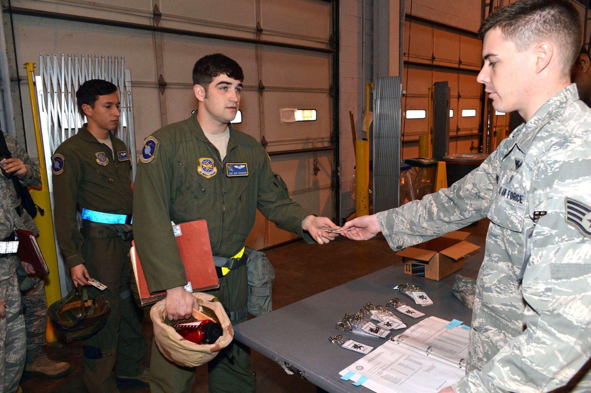 Staff Sgt. Matthew McDowell, 43d Aeromedical Evacuation Squadron, verifies the identity of Staff Sgt. Jess Trautmann, 43d Operations Support Squadron, during a 43d Airlift Group mobility exercise here Feb. 20. The four-day exercise prepared 153 personnel and 200 short tons of equipment for deployment. The objectives of the exercise were to assess and evaluate the readiness of the Group, the installation deployment plan, identify process improvement opportunities, command and control, 24-hour operations and fulfill deployment planning and execution requirement to exercise personnel and cargo deployment functions at Pope Army Airfield, Fort Bragg, N.C. (U.S. Air Force photo/Marvin Krause)