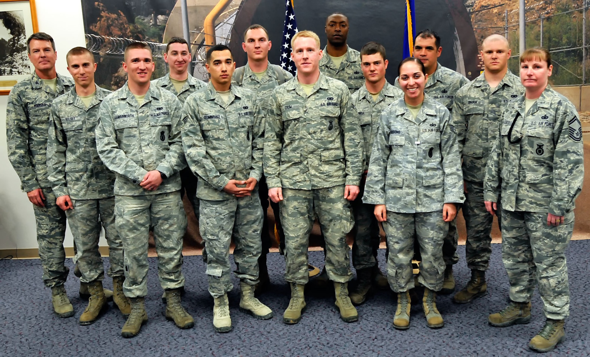 CHEYENNE MOUNTAIN AIR FORCE STATION, Colo. – Col. Travis Harsha (left), 721st Mission Support Group and Cheyenne Mountain AFS installation commander, stands with a few of the service members who were recognized for outstanding performance during the mudslide response and recovery Sept. 12, 2013, at CMAFS. A mixed group of Airmen and civilian personnel were the recipients of 21 Air Force Achievement Medals and 32 commander’s coins during a ceremony at the mountain fortress Feb. 7. Servicemembers cleaned up several thousand cubic yards of earth and debris and tons of rock at the front door of CMAFS, fully restoring the area less than six months after the slide. (U.S. Air Force photo)