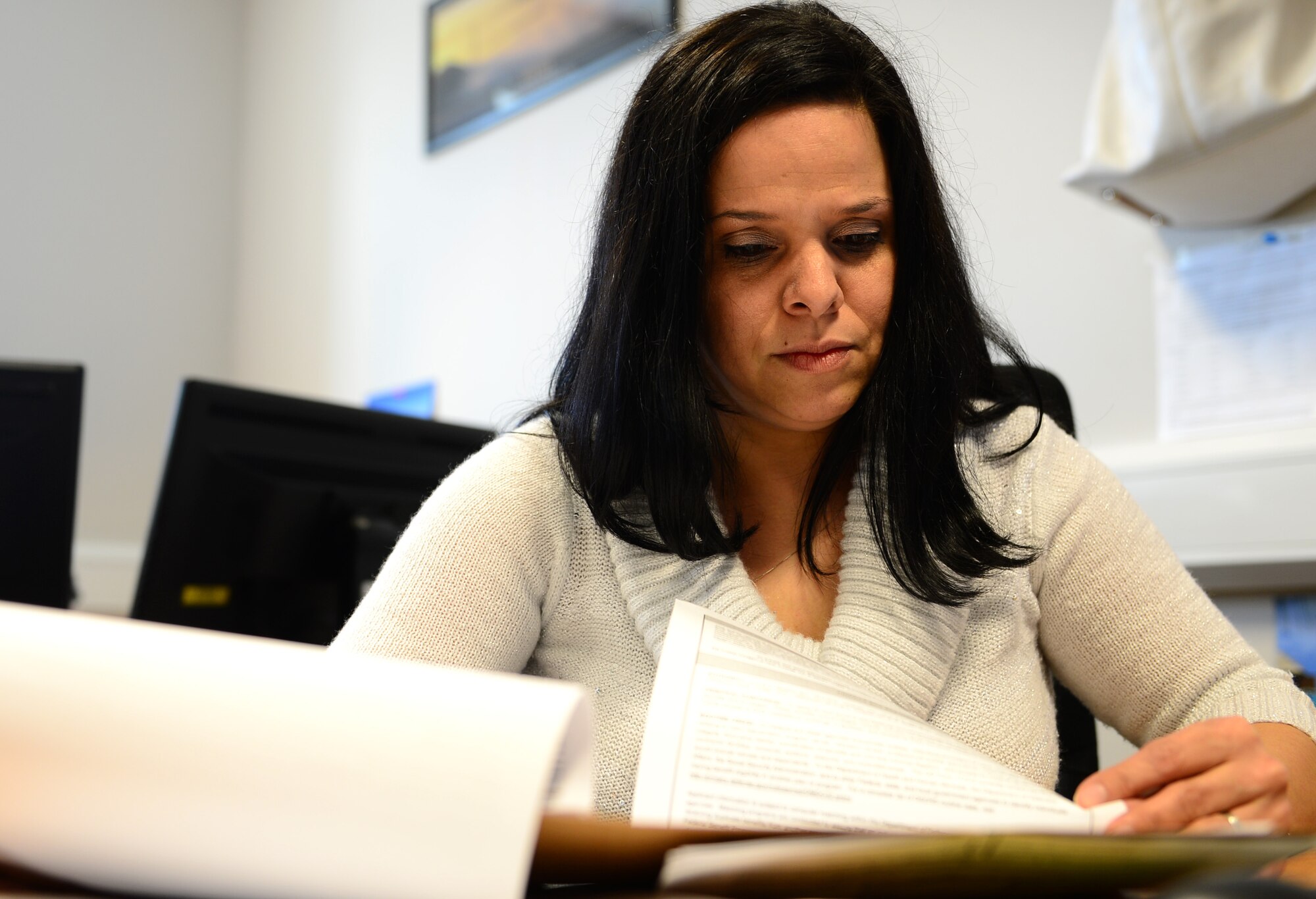 Irma Martinez-Camacho, 48th Force Support Squadron resource management coordinator, reviews paperwork, at Royal Air Force Lakenheath, England, Feb. 21, 2013. Martinez-Camacho was nominated for a Liberty Spotlight because she displays the core value of ‘Service Before Self,’ through her work as the 48th Maintenance Components Squadron key spouse. (U.S. Air Force photo by Airman 1st Class Dawn M. Weber/Released)