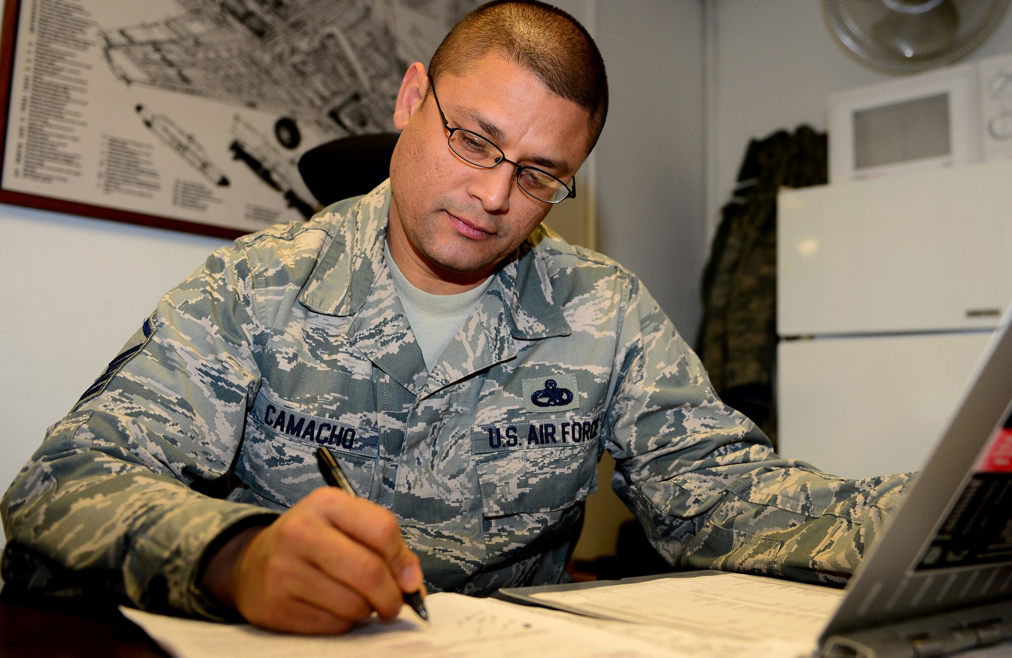 Master Sgt. Richard Camacho, 48th Components Maintenance Squadron jet engine production manager, reviews production schedules at Royal Air Force Lakenheath, England, Feb. 21, 2014. Camacho was nominated for a Liberty Spotlight because he displays the core value of ‘Service Before Self.’ (U.S. Air Force photo by Airman 1st Class Dawn M. Weber/Released)