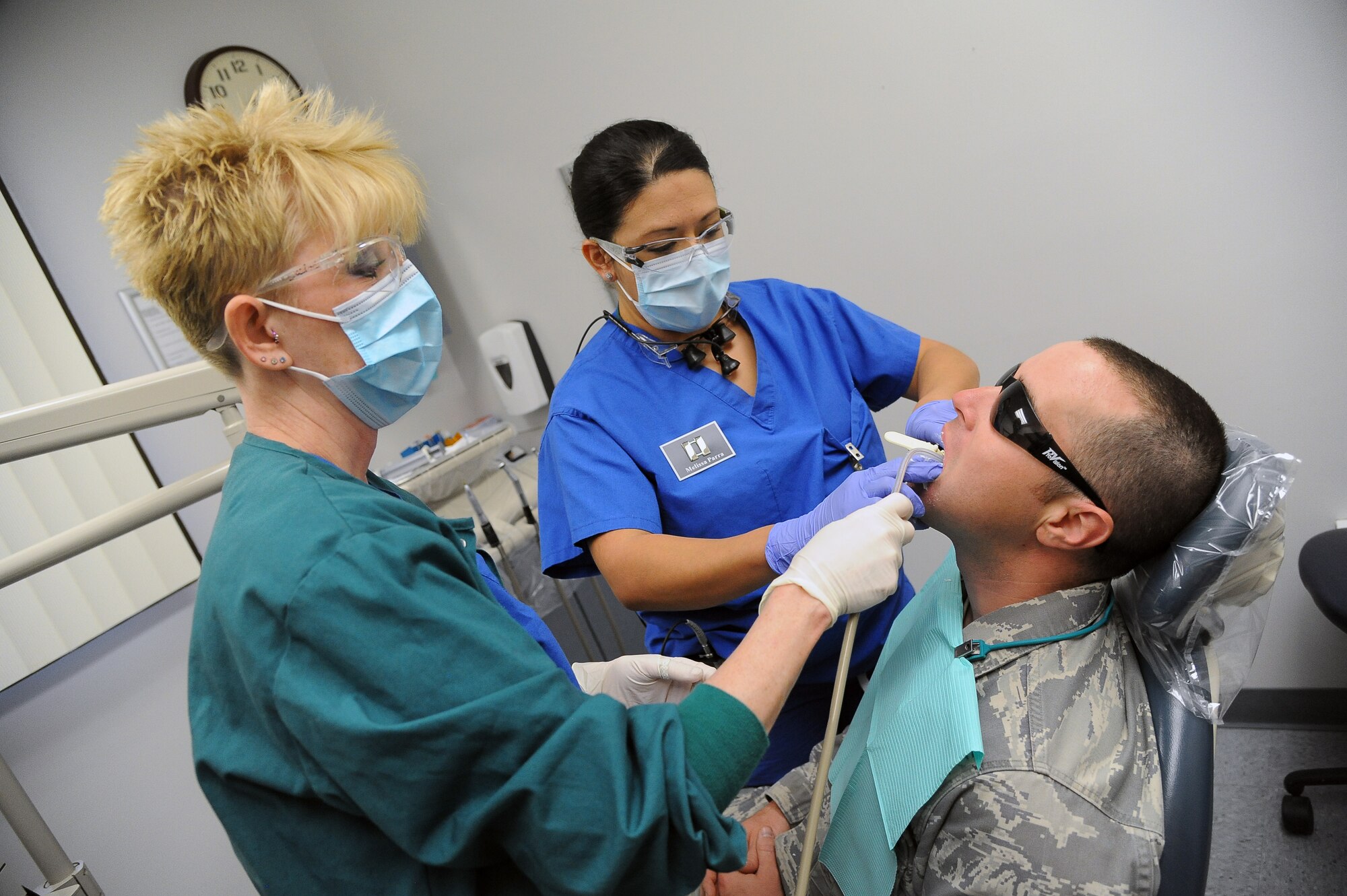 Capt. Melissa Parra, 56th Dental Squadron dentist, and her assistant, Karen St. Aubin, take an impression for a cast study Monday on Tech. Sgt. Daniel Pottinger, 944th Security Forces Squadron fire team member, at Luke Air Force Base. (U.S. Air Force photo/Airman 1st Class Pedro Mota)