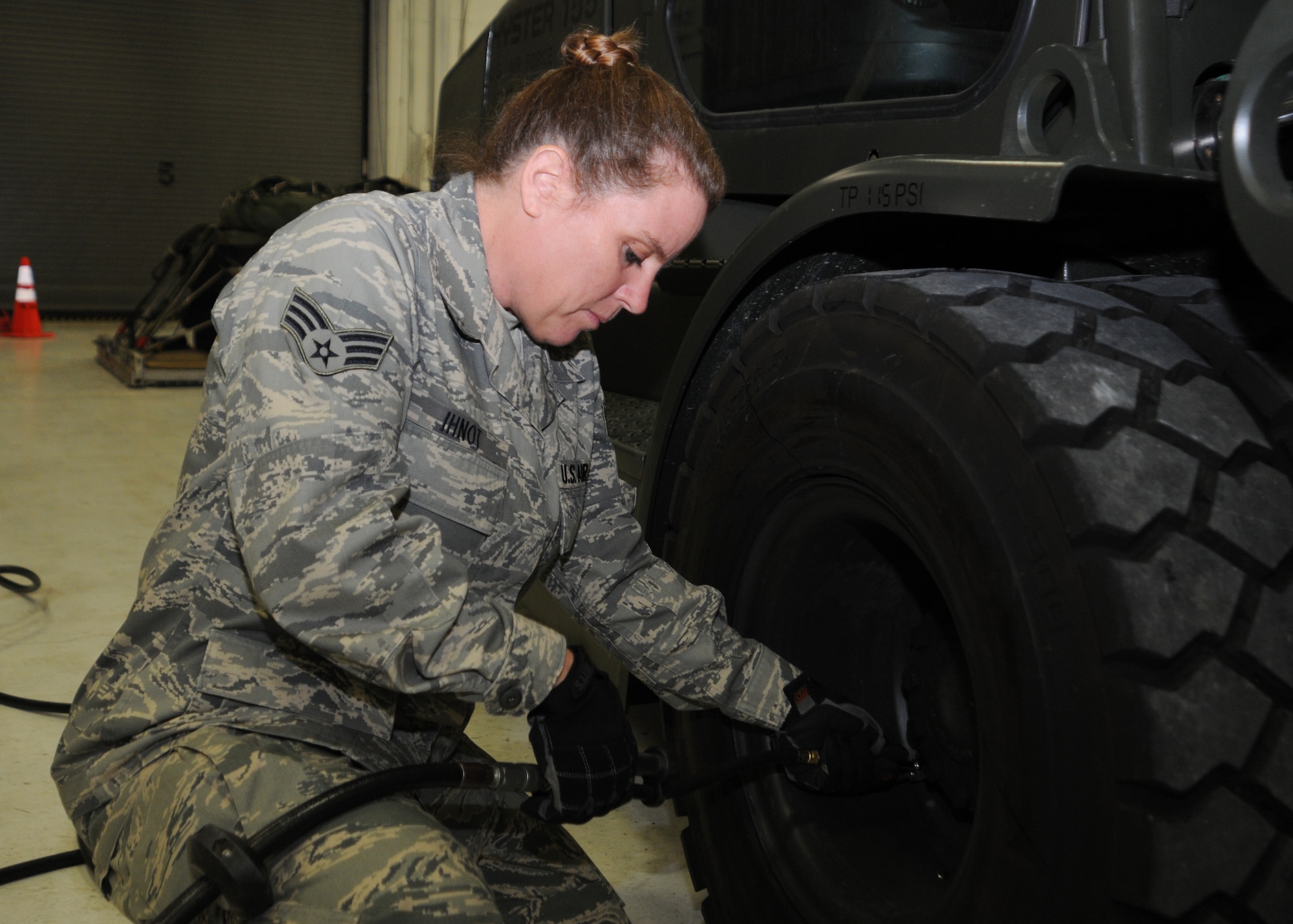 YOUNGSTOWN AIR RESERVE STATION, Ohio—U.S. Air Force Reserve Senior Airman Tiffany Ihnot, 76th Aerial Port Squadron air transportation specialist, inflates a forklift tire here, Feb. 1, 2014. Airmen perform daily maintenance checks on forklifts and other equipment to ensure safe operation. (U.S. Air Force photo/Senior Airman Rachel Kocin).