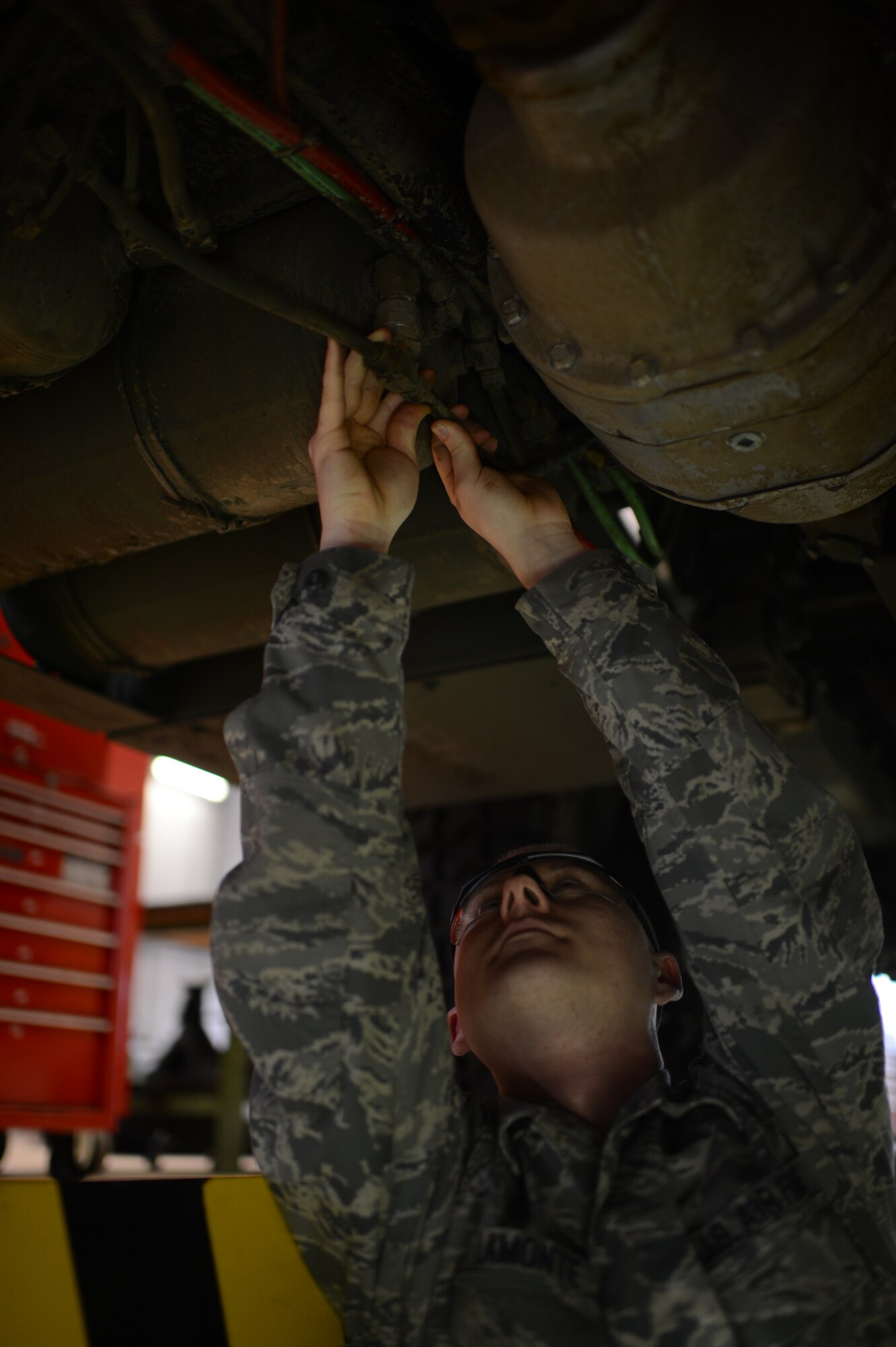U.S. Air Force Staff Sgt. Michael Lamonte, 606th Air Control Squadron vehicle maintenance technician from Burlington, Calif., checks the air lines of a five-ton troop carrier vehicle on Spangdahlem Air Base, Germany, Feb. 21, 2014. The air lines are checked for leaks during maintenance to ensure proper function of the vehicle. (U.S. Air Force photo by Senior Airman Gustavo Castillo/Released)