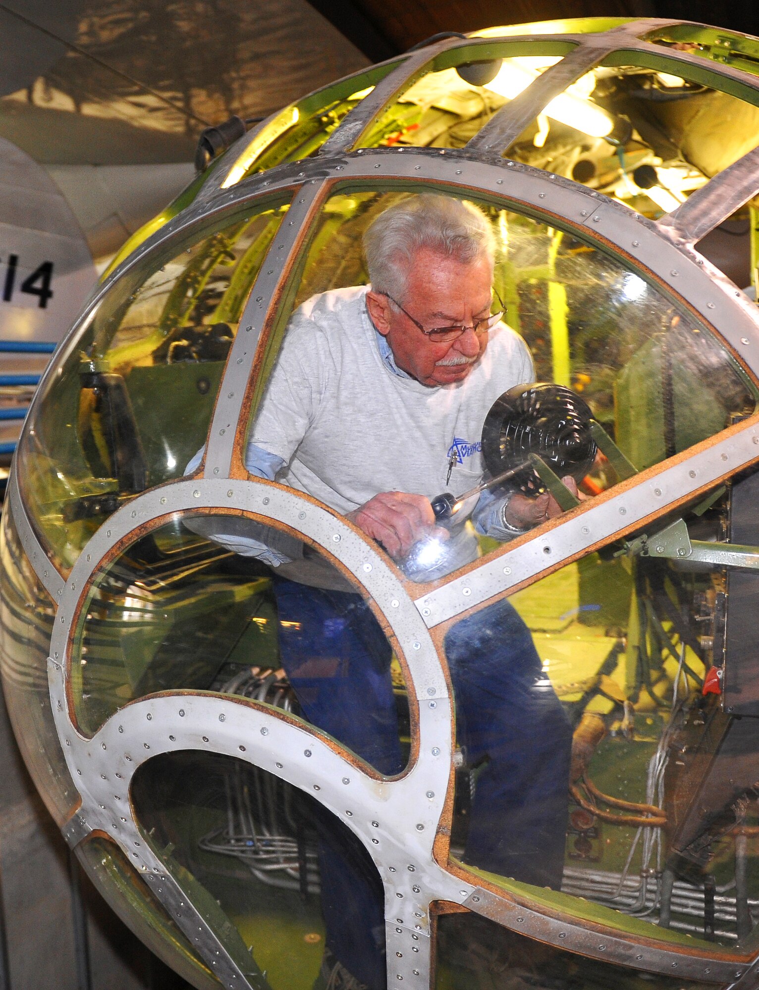 Bob Denison, Museum of Aviation volunteer, works to completely restore the nose section of a B-29 aircraft currently on display in the museum’s World War II Building. (U.S. Air Force photo by Tommie Horton)