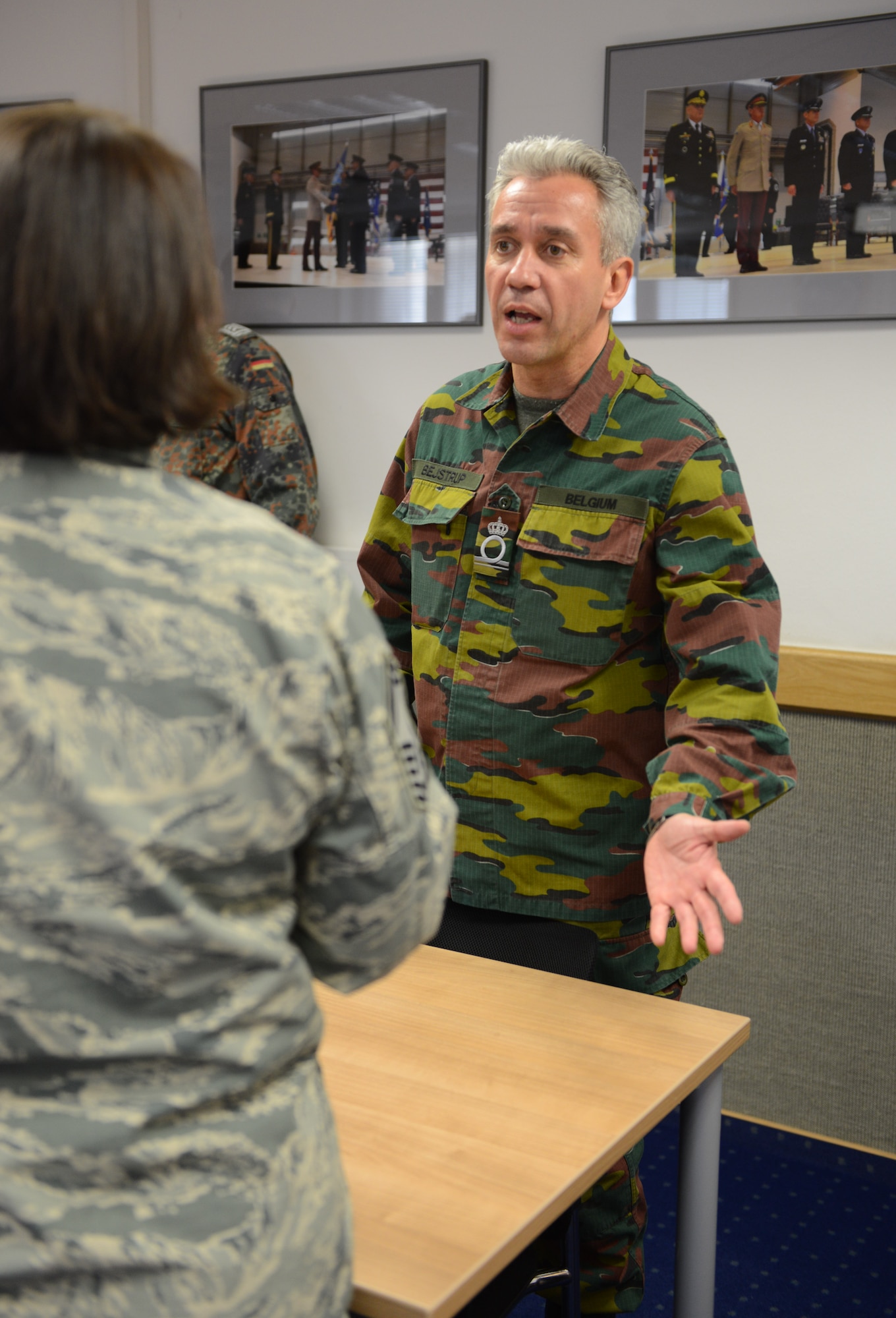 KAPAUN AIR STATION, Germany -- Command Sergeant Major Erik Bejstrup, Belgian air force, speaks with a member of the Kisling Non-Commissioned Officer Academy during a tour of the facility here Feb. 20, 2014. Bejstrup took part in a tour of the academy as part of the Kaiserslautern Military Community First Sergeant Council's Additional Duty First Sergeant Symposium. The symposium featured international attendees for the first time in its history and covered many key roles and responsibilities of the first sergeant position.  (U.S. Air Force Photo By Tech. Sgt. James M. Hodgman)