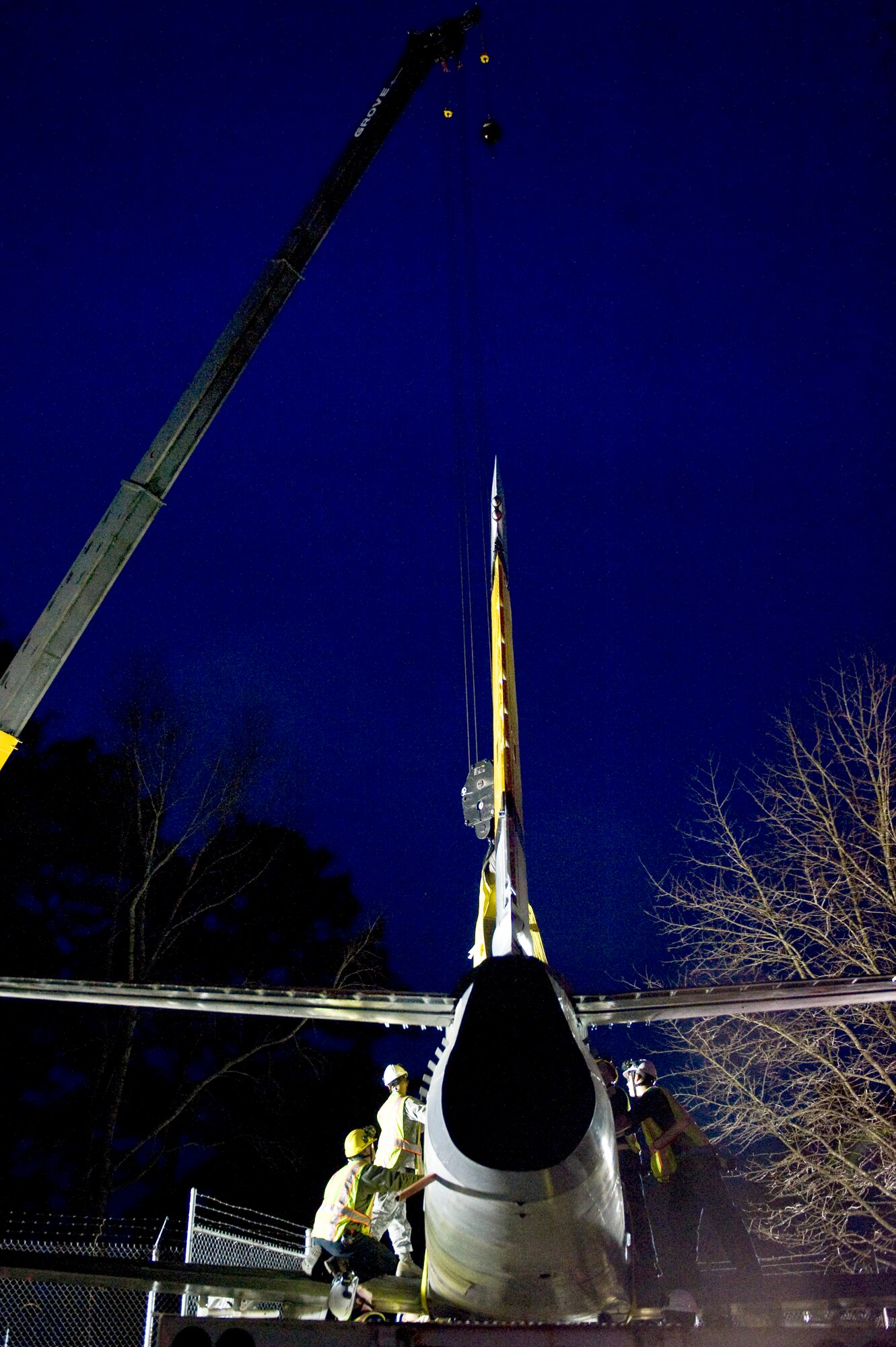 Airmen from the 4th Equipment Maintenance Squadron secure an F-86 Sabre aircraft to a crane, Feb. 20, 2014, at Seymour Johnson Air Force Base, N.C.  The 4th Fighter Wing has a long-standing history with the Sabre, becoming the first group to fly the aircraft during the Korean War. Airmen from the 4th EMS will restore the aircraft, which belongs to the Goldsboro Police Department, during the next few months to fix structural and cosmetic flaws. Once completed, the aircraft will be returned to city for display. (U.S. Air Force photo by Airman 1st Class Brittain Crolley)