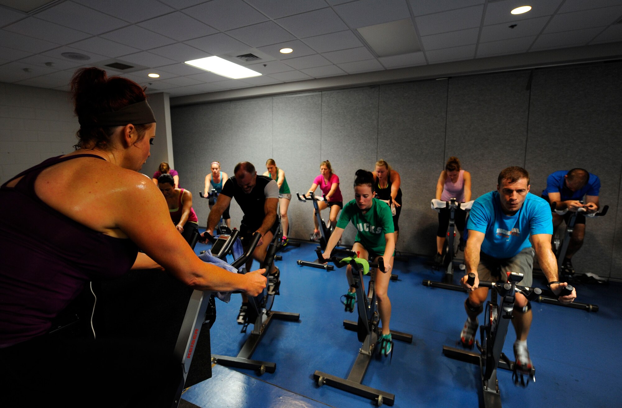 Lisa Pizzo, lead group fitness instructor, instructs her class during a cycle workout at Hurlburt Field, Fla., Feb. 20, 2014. Pizzo said she has taught at the Aderholt Gym since 2005. (U.S. Air Force photo/Airman 1st Class Andrea Posey)