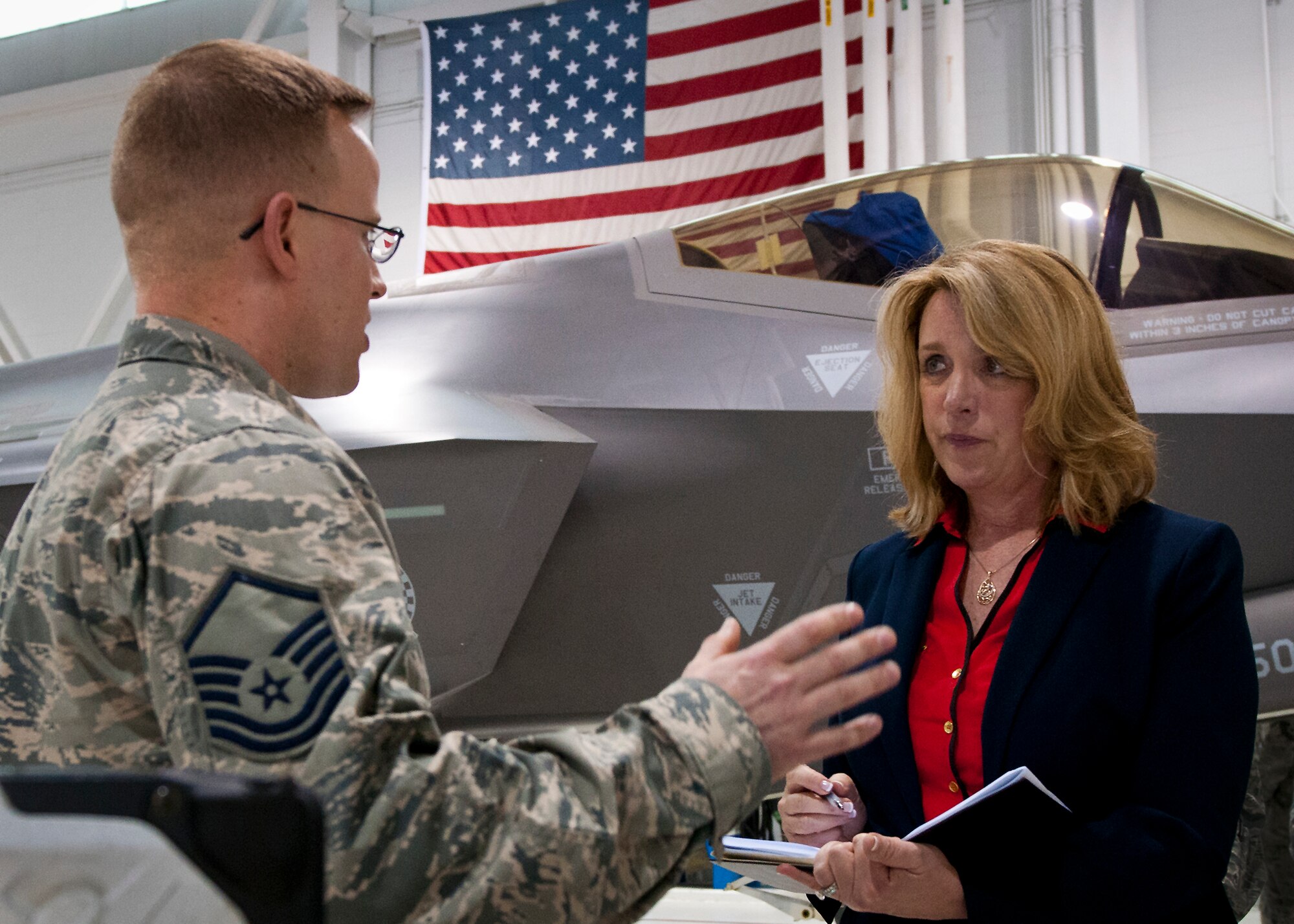 Master Sgt. Gabriel Lausen, of the 33rd Fighter Wing, briefs Secretary of the Air Force Deborah Lee James on the F-35A Lightning II’s stealth coating Feb. 19 at Eglin Air Force Base, Fla.  James’ visit focused primarily on the joint strike fighter with visits to the Academic Training Center and reprograming lab and meeting with pilots and maintainers.  (U.S. Air Force photo/Samuel King Jr.)