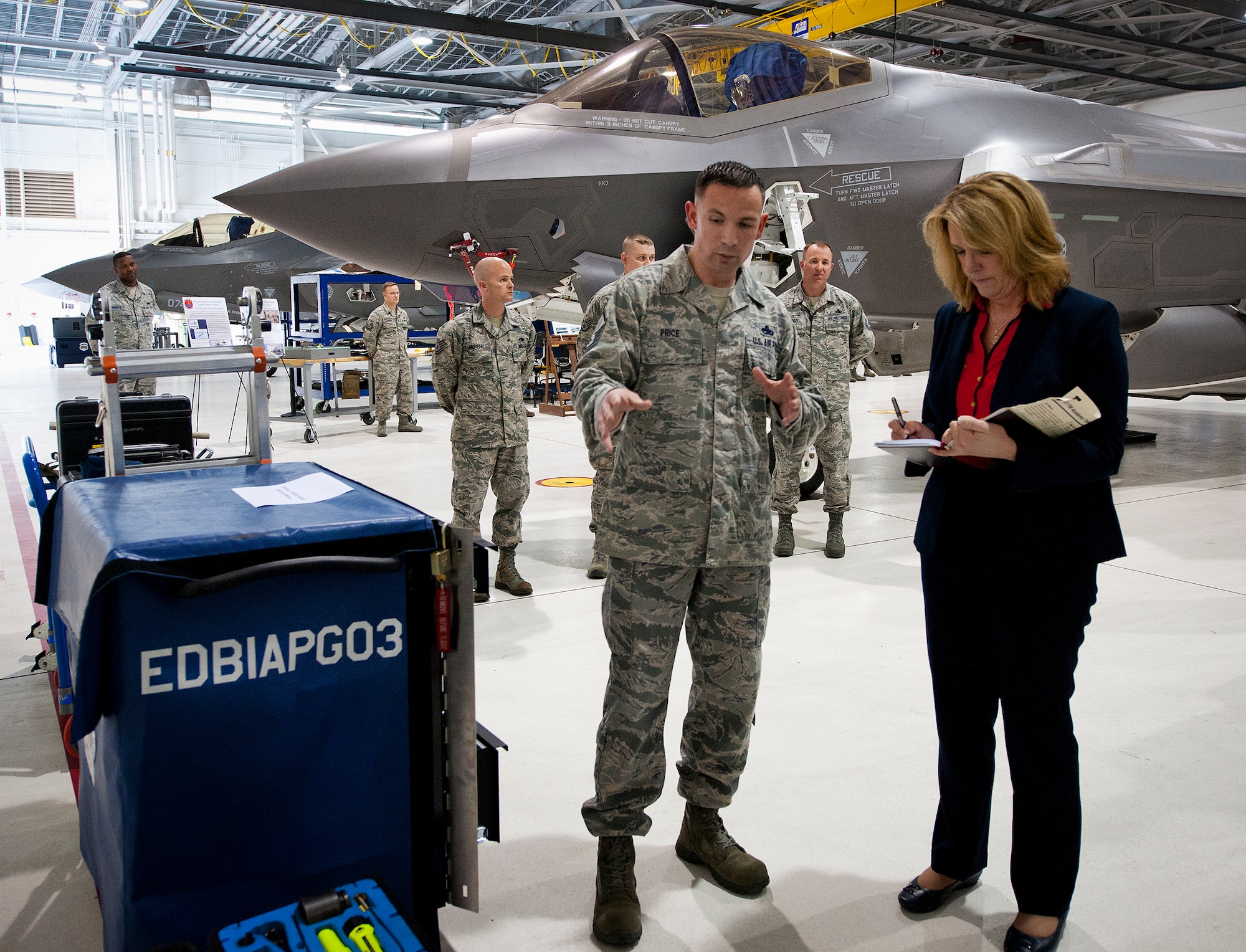 Master Sgt. Donald Price, of the 33rd Aircraft Maintenance Squadron, briefs Secretary of the Air Force Deborah Lee James on local tool innovations created to help maintainers work on the F-35A Lightning II Feb. 19 at Eglin Air Force Base, Fla.  James’ visit focused primarily on the joint strike fighter with visits to the Academic Training Center and reprograming lab and meeting with pilots and maintainers.  (U.S. Air Force photo/Samuel King Jr.)