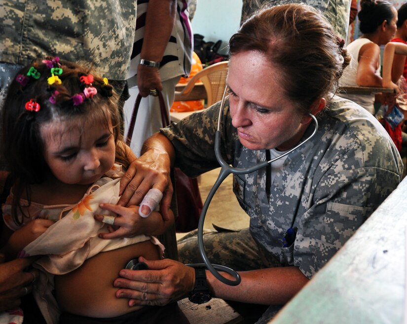 U.S. Army Maj. Vicki English, Joint Task Force-Bravo Medical Element (MEDEL), examines a young Honduran girl during a Medical Readiness Training Exercise (MEDRETE) in the town of Caoba in the Department of Cortes, Honduras, Feb. 20, 2014. Medical professionals from Joint Task Force-Bravo partner with the Honduran Ministry of Health and the Honduran military to provide medical care to underserviced populations throughout Honduras. In the last six months, MEDEL has partnered with the Honduran Ministry of Health to provide care for more than 6,000 Hondurans. (U.S. Air Force photo by Capt. Zach Anderson)