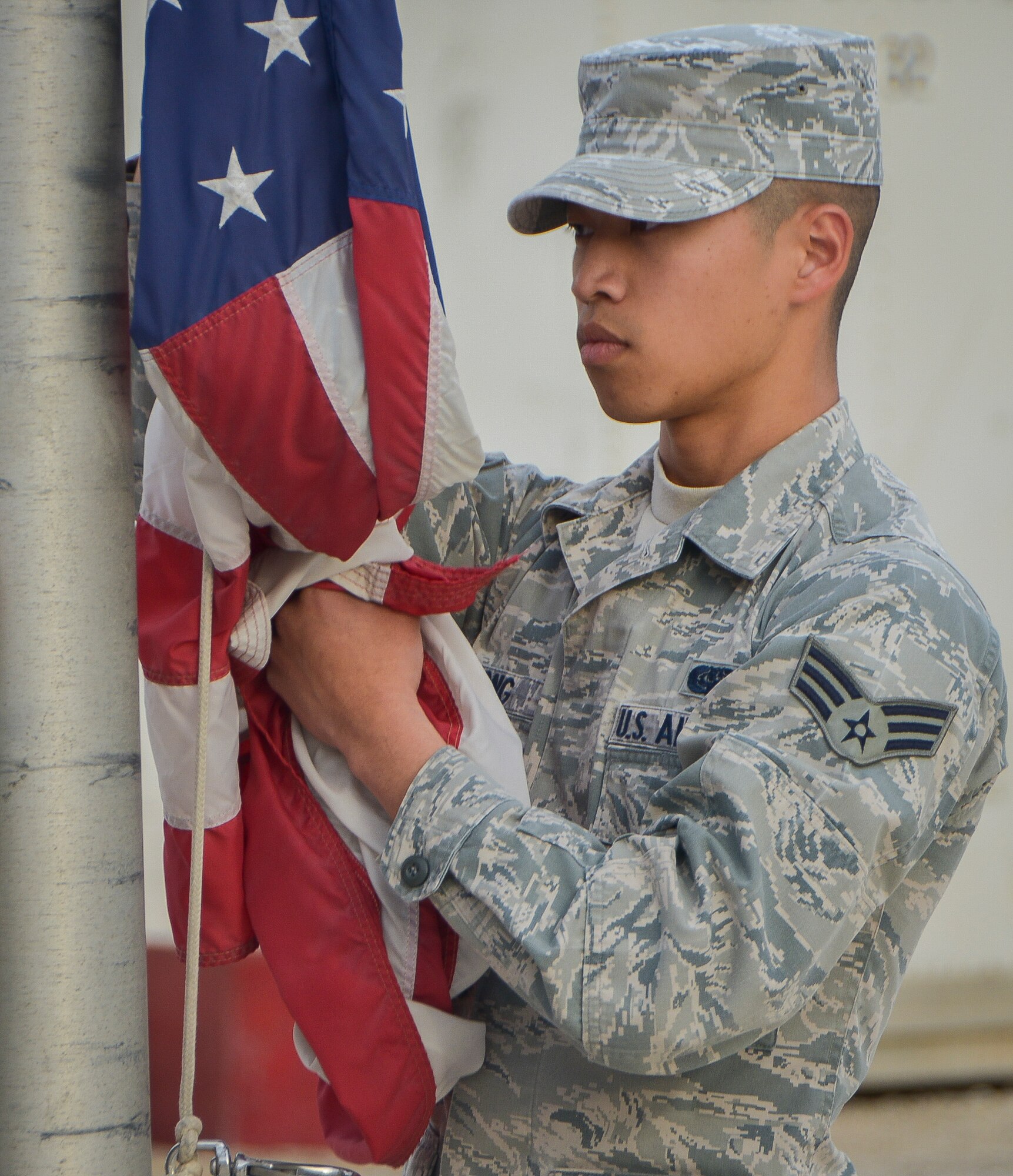 Senior Airman Suchi Xiong who is part of the base’s honor guard team secures the U.S. Flag during a Presidents Day retreat ceremony at Al Udeid Air Base, Qatar, Feb. 17, 2014. In 1951, the desire for a more generalized recognition of Presidential achievements surfaced and collided with a movement to standardize the observance of certain holidays on Mondays, which would later come to be known as the “Uniform Monday Holiday Act”. Contrary to popular belief, the act neither combined the birthday celebrations for Presidents George Washington and Abraham Lincoln nor actually changed the holiday’s official name to Presidents Day. Xiong is deployed from Joint Base Andrews, Md., and hails from Fresno City, Calif. (U.S. Air Force photo/Senior Airman Jared Trimarchi) 